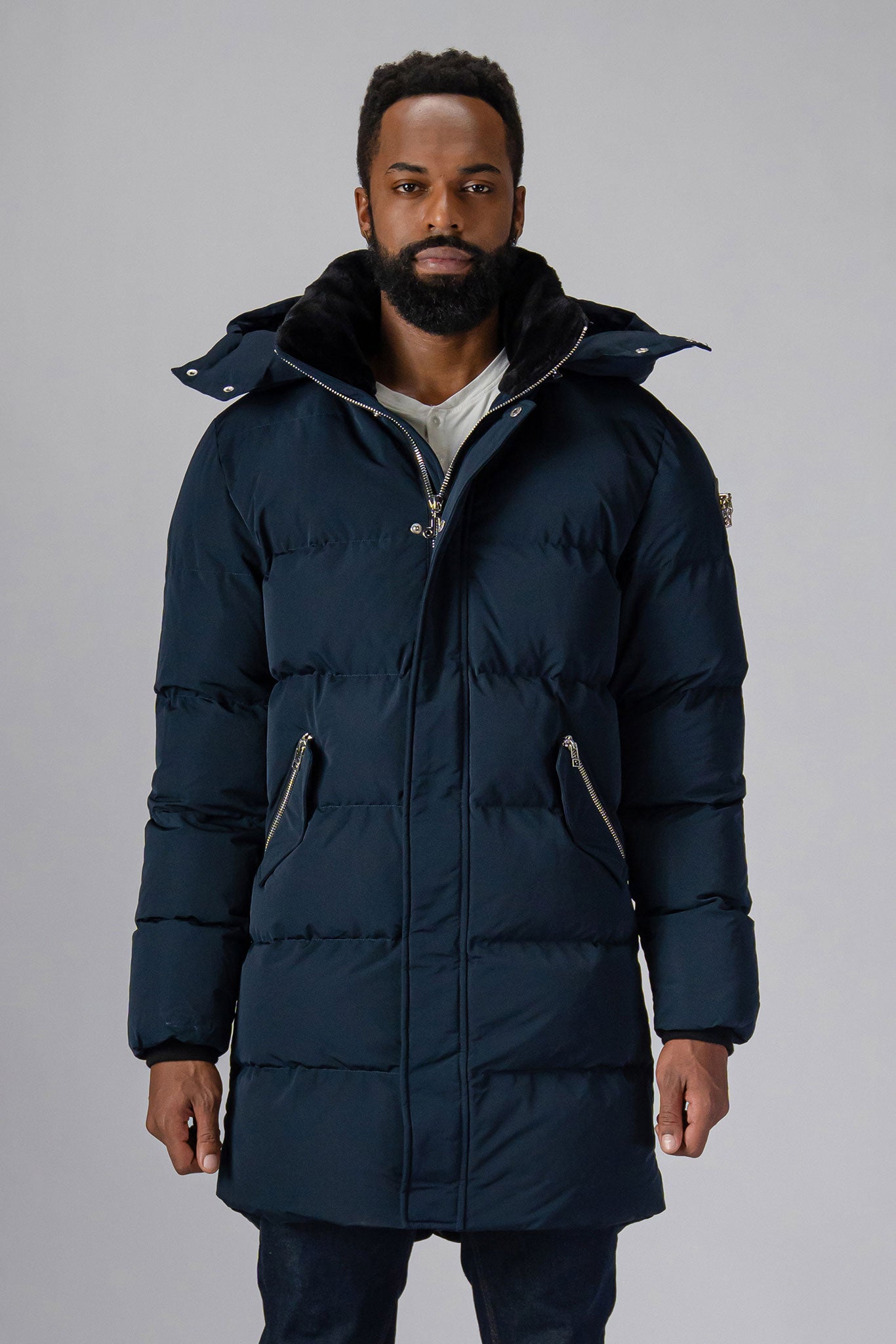 Woodpecker Men's Penguin Long Winter coat. High-end Canadian designer winter coat for men in “Matte Navy" colour. Woodpecker cruelty-free winter coat designed in Canada. Men's heavy weight long length premium designer jacket for winter. Superior quality warm winter coat for men. Moose Knuckles, Canada Goose, Mackage, Montcler, Will Poho, Willbird, Nic Bayley. Extra warm. Shiny parka. Stylish winter jacket. Designer winter coat.