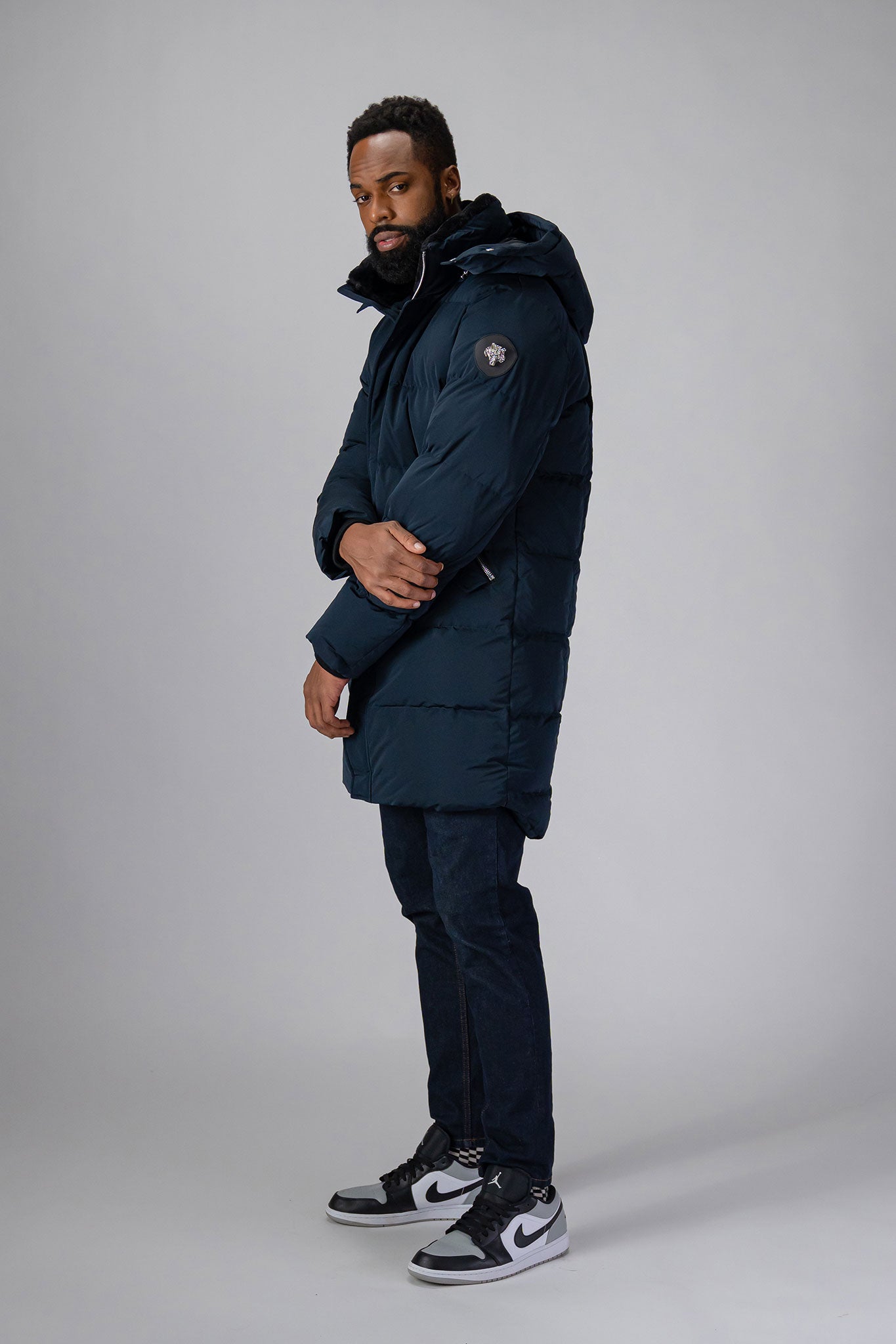 Woodpecker Men's Penguin Long Winter coat. High-end Canadian designer winter coat for men in “Matte Navy" colour. Woodpecker cruelty-free winter coat designed in Canada. Men's heavy weight long length premium designer jacket for winter. Superior quality warm winter coat for men. Moose Knuckles, Canada Goose, Mackage, Montcler, Will Poho, Willbird, Nic Bayley. Extra warm. Shiny parka. Stylish winter jacket. Designer winter coat.