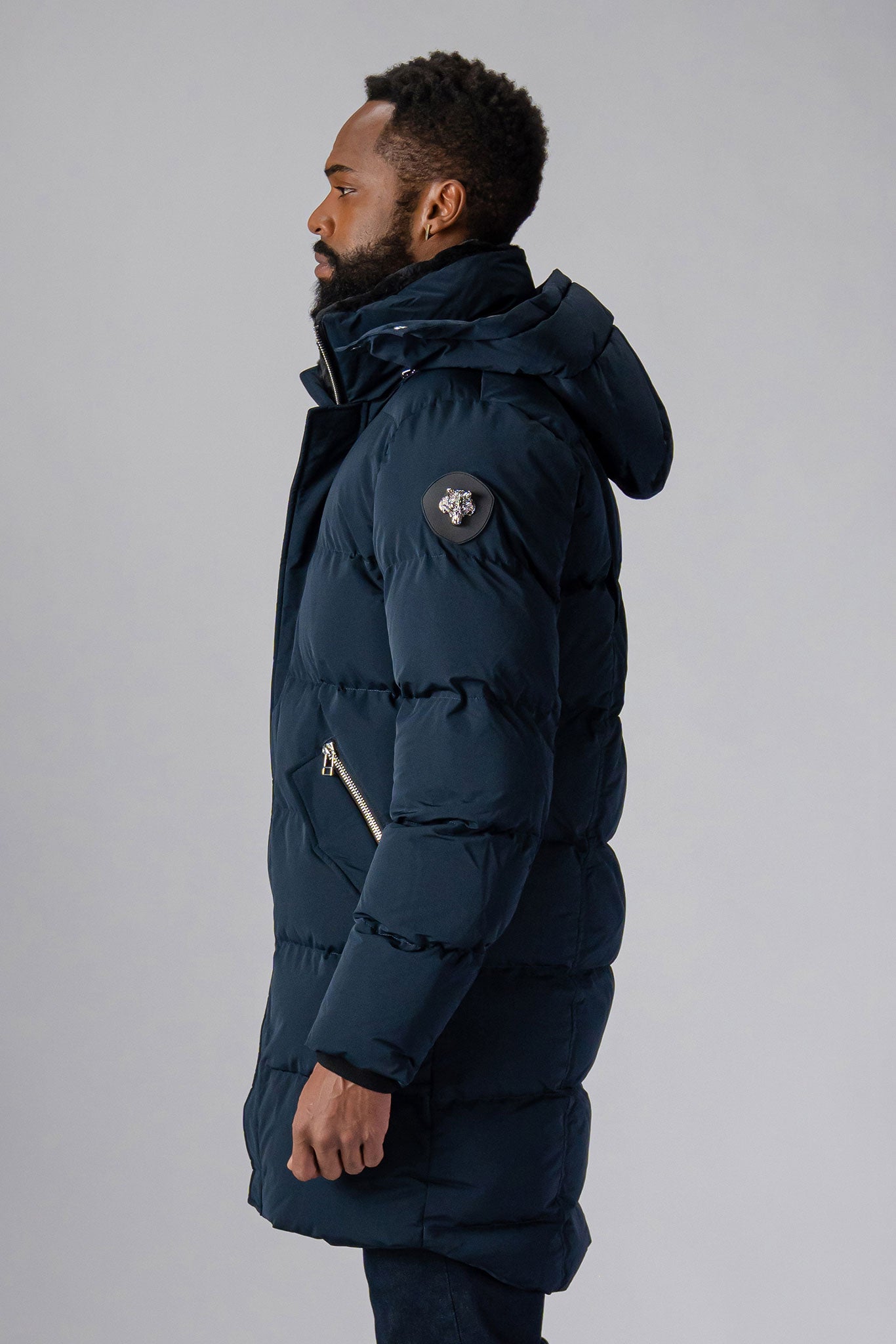 Woodpecker Men's Penguin Long Winter coat. High-end Canadian designer winter coat for men in “Matte Navy" colour. Woodpecker cruelty-free winter coat designed in Canada. Men's heavy weight long length premium designer jacket for winter. Superior quality warm winter coat for men. Moose Knuckles, Canada Goose, Mackage, Montcler, Will Poho, Willbird, Nic Bayley. Extra warm. Shiny parka. Stylish winter jacket. Designer winter coat.