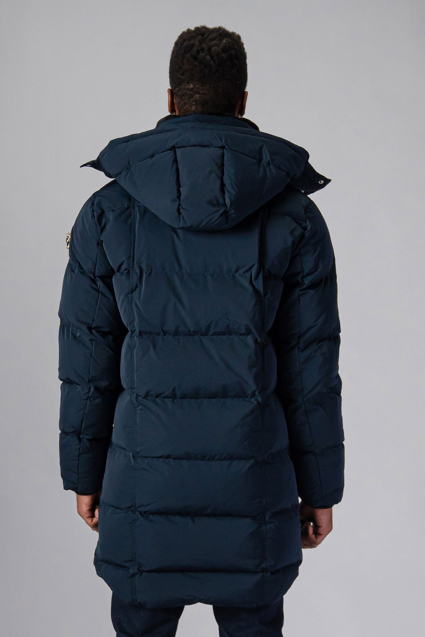 Woodpecker Men's Penguin Long Winter coat. High-end Canadian designer winter coat for men in “Matte Navy" colour. Woodpecker cruelty-free winter coat designed in Canada. Men's heavy weight long length premium designer jacket for winter. Superior quality warm winter coat for men. Moose Knuckles, Canada Goose, Mackage, Montcler, Will Poho, Willbird, Nic Bayley. Extra warm. Shiny parka. Stylish winter jacket. Designer winter coat.
