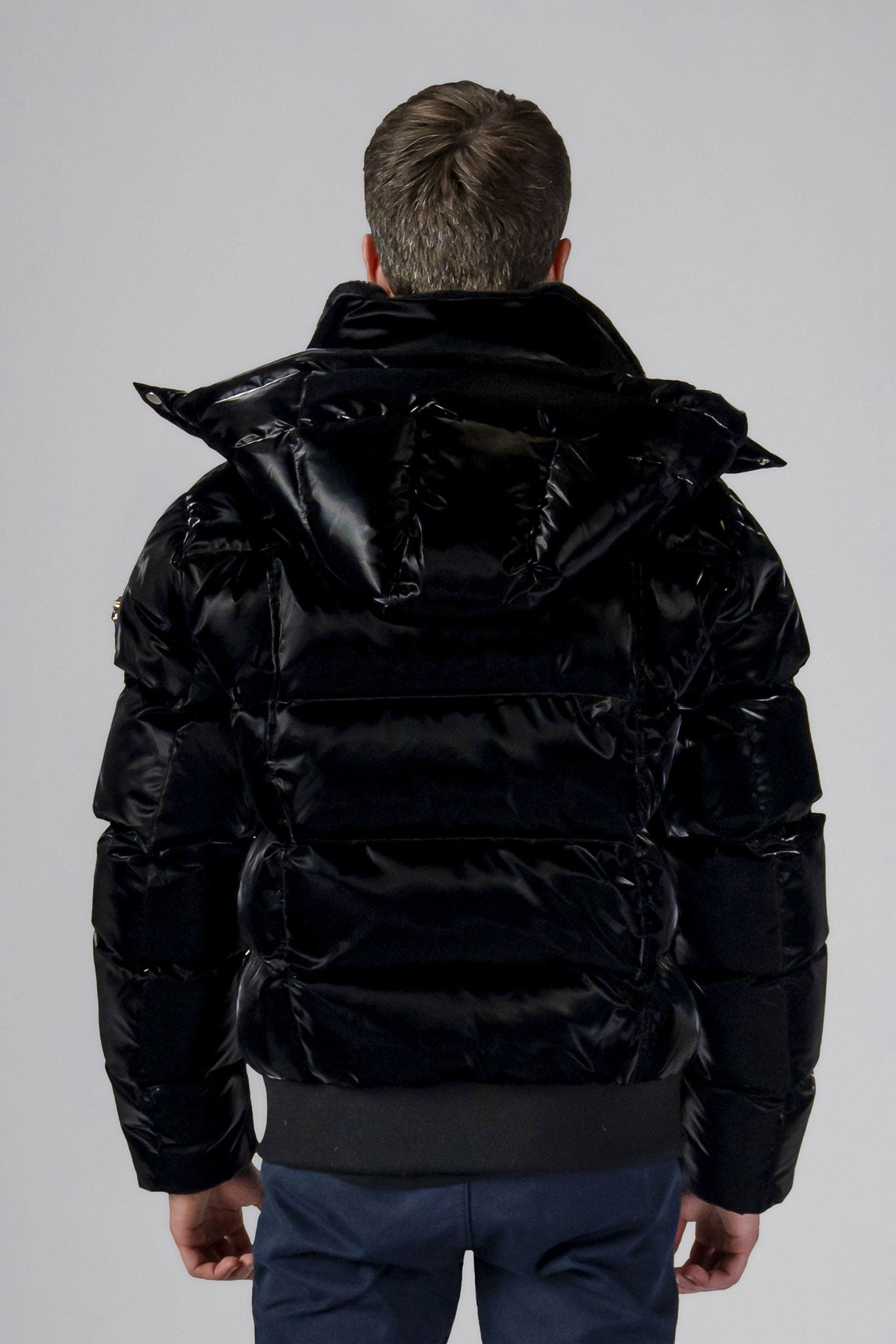 Woodpecker Men's Woody Bomber Winter coat. High-end Canadian designer winter coat for men in shiny “All Wet Black" colour. Woodpecker cruelty-free winter coat designed in Canada. Men's heavy weight short length premium designer jacket for winter. Superior quality warm winter coat for men. Moose Knuckles, Canada Goose, Mackage, Montcler, Will Poho, Willbird, Nic Bayley. Shiny parka. Stylish winter jacket. Designer winter coat.