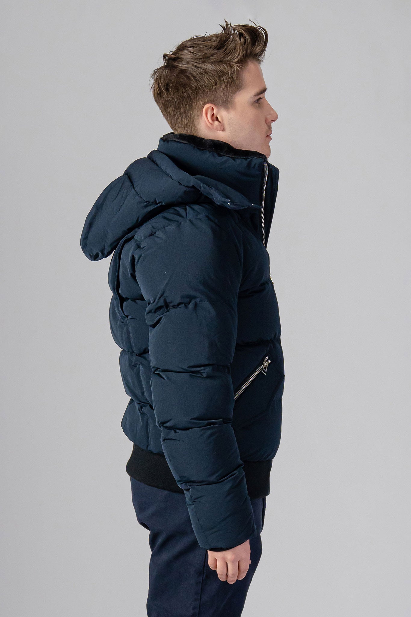 Woodpecker Men's Woody Bomber Winter coat. High-end Canadian designer winter coat for men in “Matte Navy" colour. Woodpecker cruelty-free winter coat designed in Canada. Men's heavy weight short length premium designer jacket for winter. Superior quality warm winter coat for men. Moose Knuckles, Canada Goose, Mackage, Montcler, Will Poho, Willbird, Nic Bayley. Shiny parka. Stylish winter jacket. Designer winter coat.