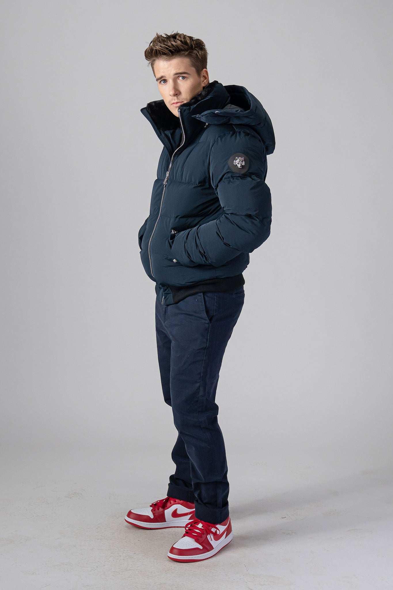 Woodpecker Men's Woody Bomber Winter coat. High-end Canadian designer winter coat for men in “Matte Navy" colour. Woodpecker cruelty-free winter coat designed in Canada. Men's heavy weight short length premium designer jacket for winter. Superior quality warm winter coat for men. Moose Knuckles, Canada Goose, Mackage, Montcler, Will Poho, Willbird, Nic Bayley. Shiny parka. Stylish winter jacket. Designer winter coat.