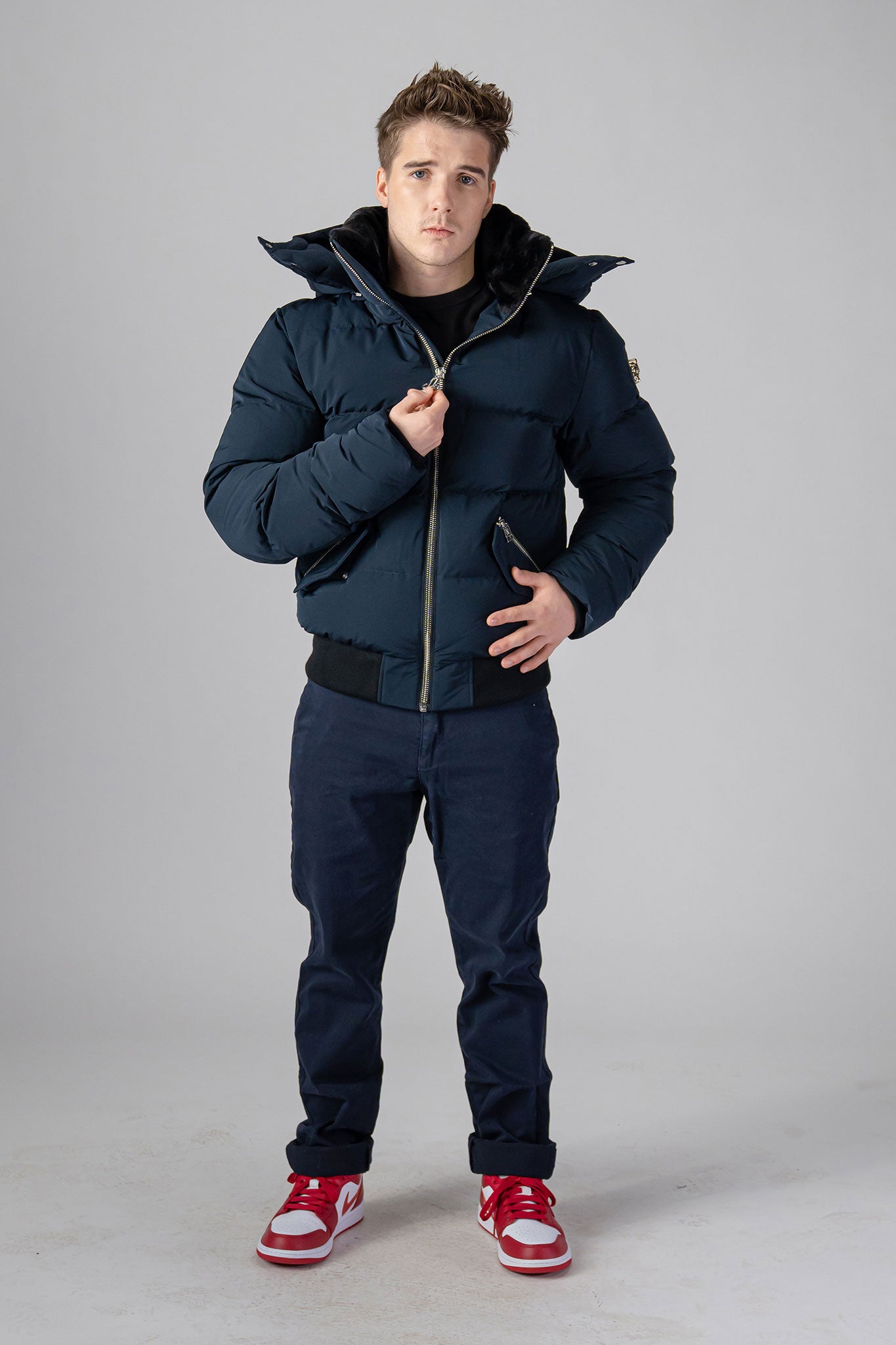 Woodpecker Men's Woody Bomber Winter coat. High-end Canadian designer winter coat for men in “Matte Navy" colour. Woodpecker cruelty-free winter coat designed in Canada. Men's heavy weight short length premium designer jacket for winter. Superior quality warm winter coat for men. Moose Knuckles, Canada Goose, Mackage, Montcler, Will Poho, Willbird, Nic Bayley. Shiny parka. Stylish winter jacket. Designer winter coat.