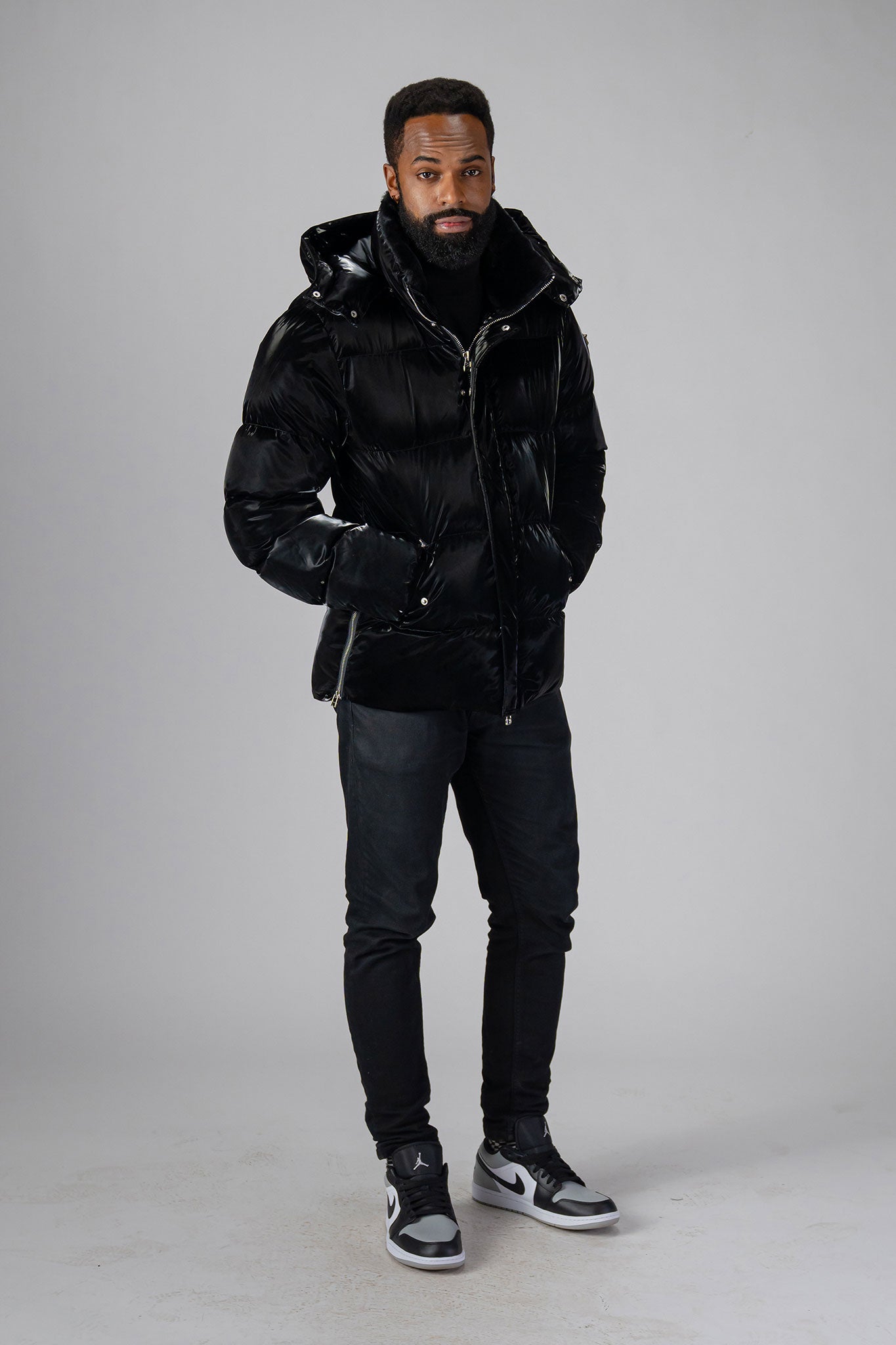 Woodpecker Men's Bumnester Winter coat. High-end Canadian designer winter coat for men in "All Wet Black" colour. Woodpecker cruelty-free winter coat designed in Canada. Men's heavy weight medium length premium designer jacket for winter. Superior quality warm winter coat for men. Moose Knuckles, Canada Goose, Mackage, Montcler, Will Poho, Willbird, Nic Bayley. Shiny parka. Stylish winter jacket. Designer winter coat.