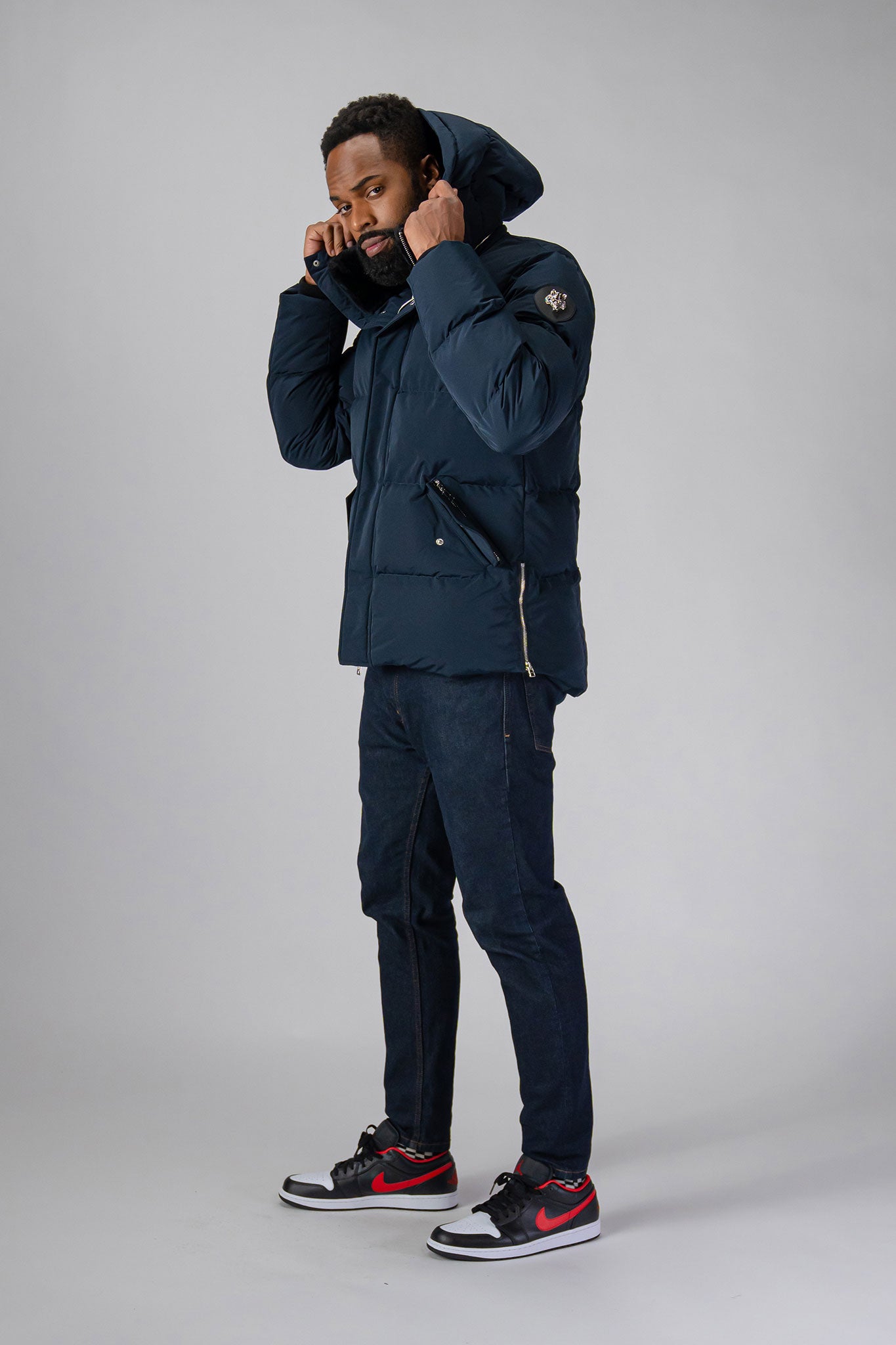 High-end Canadian designer winter coat for men in "Matte Navy" colour. Woodpecker cruelty-free winter coat designed in Canada. Men's heavy weight medium length premium designer jacket for winter. Superior quality warm winter coat for men. Moose Knuckles, Canada Goose, Mackage, Montcler, Will Poho, Willbird, Nic Bayley. Shiny parka. Stylish winter jacket. Designer winter coat.