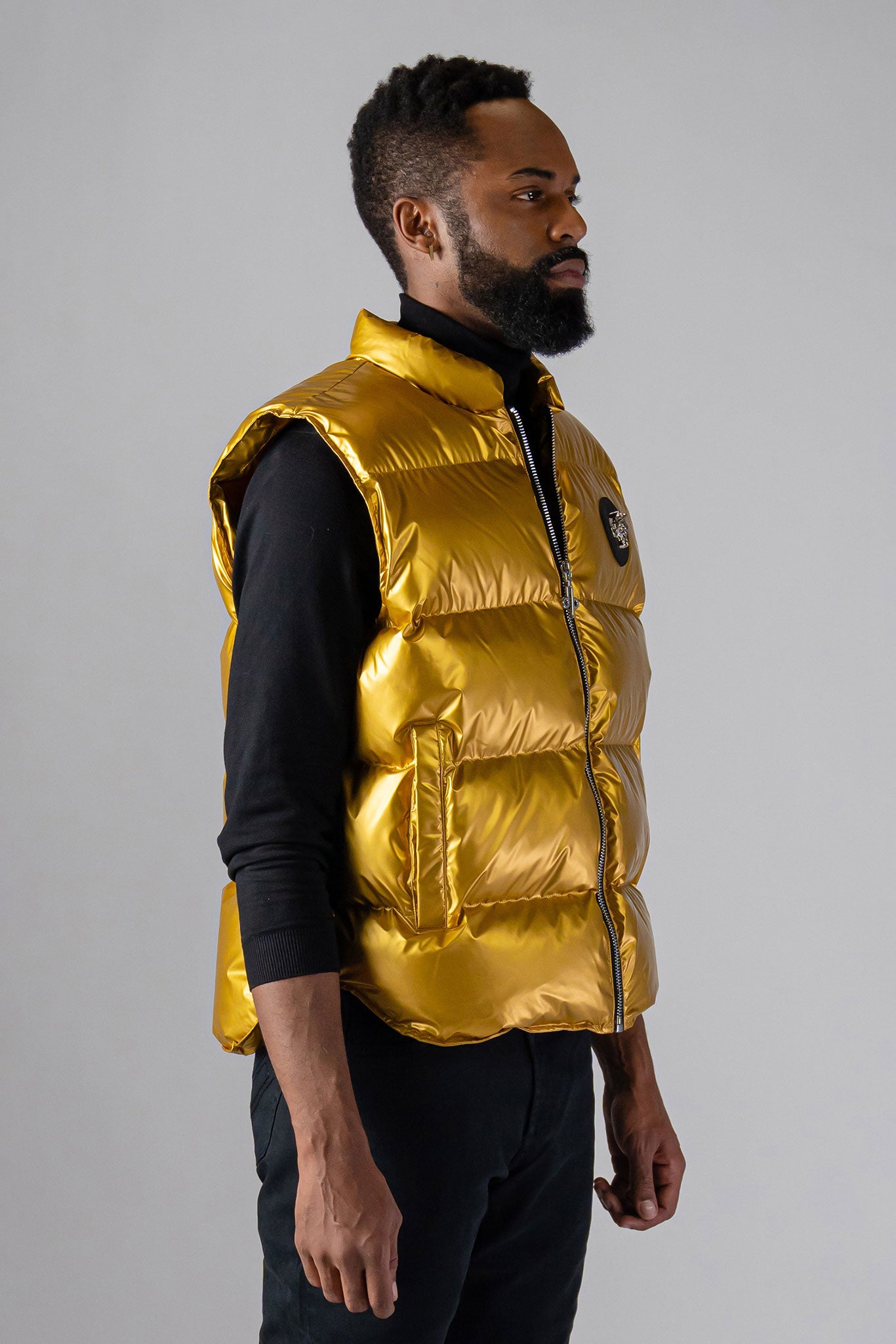 Woodpecker Unisex Winter Vest. High-end Canadian designer winter vest in "Gold" colour. Woodpecker cruelty-free vest designed in Canada. Heavy weight short length premium designer vest for winter. Superior quality warm winter vest. Moose Knuckles, Canada Goose, Mackage, Montcler, Will Poho, Willbird, Nic Bayley. Extra warm. Shiny vest. Stylish winter vest. Designer winter vest.