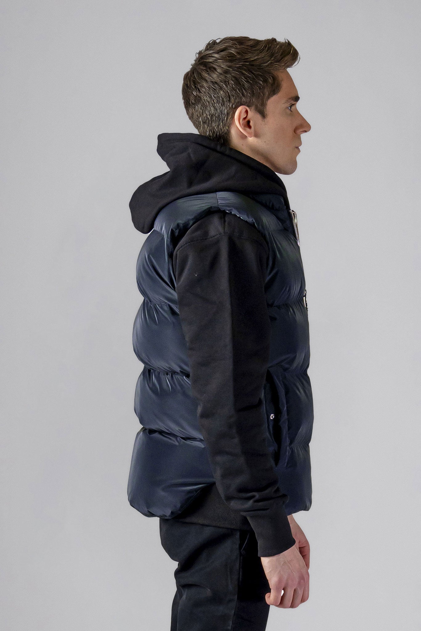 Woodpecker Unisex Winter Vest. High-end Canadian designer winter vest in "Blue Diamond" colour. Woodpecker cruelty-free vest designed in Canada. Heavy weight short length premium designer vest for winter. Superior quality warm winter vest. Moose Knuckles, Canada Goose, Mackage, Montcler, Will Poho, Willbird, Nic Bayley. Extra warm. Shiny vest. Stylish winter vest. Designer winter vest.