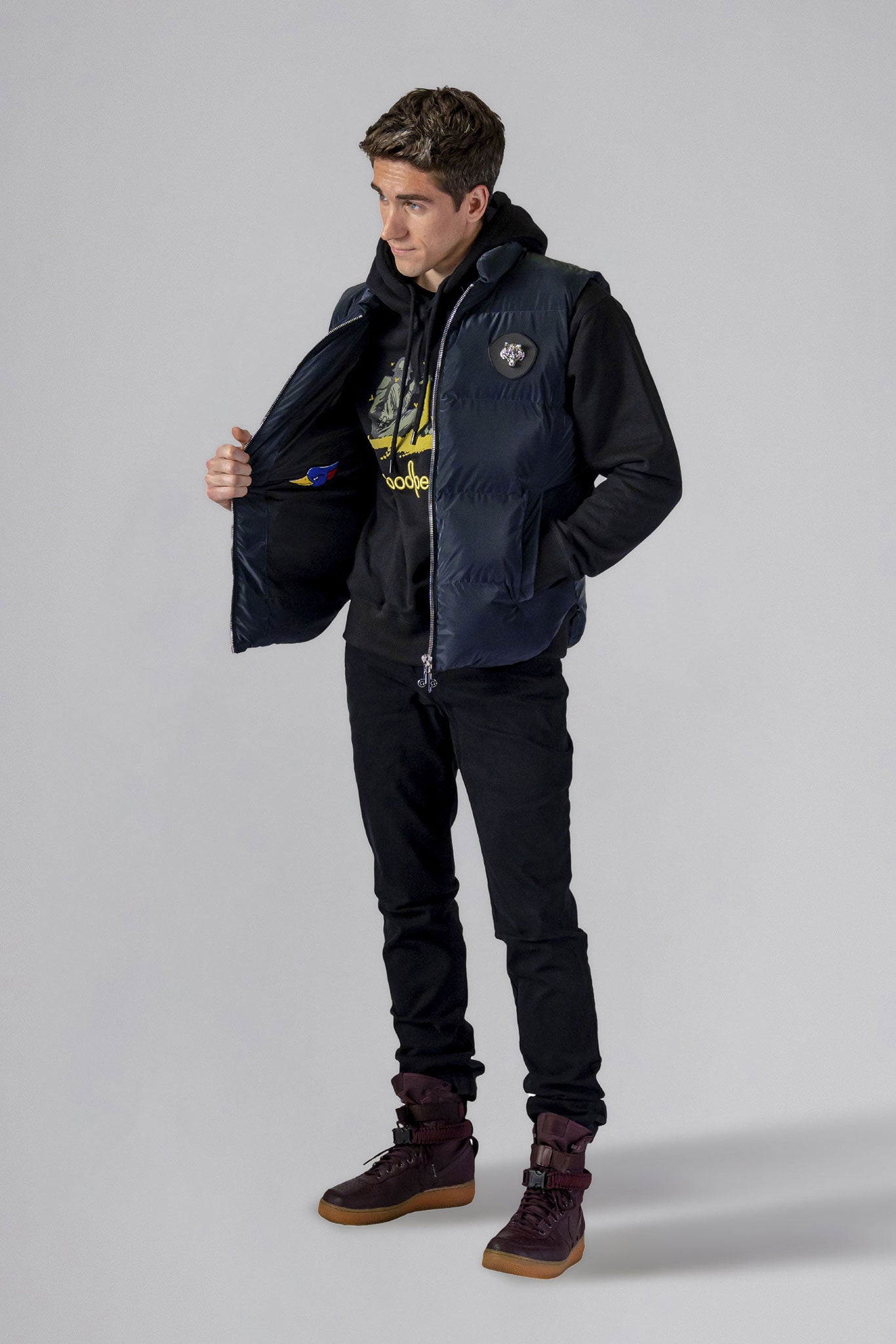 Woodpecker Unisex Winter Vest. High-end Canadian designer winter vest in "Blue Diamond" colour. Woodpecker cruelty-free vest designed in Canada. Heavy weight short length premium designer vest for winter. Superior quality warm winter vest. Moose Knuckles, Canada Goose, Mackage, Montcler, Will Poho, Willbird, Nic Bayley. Extra warm. Shiny vest. Stylish winter vest. Designer winter vest.