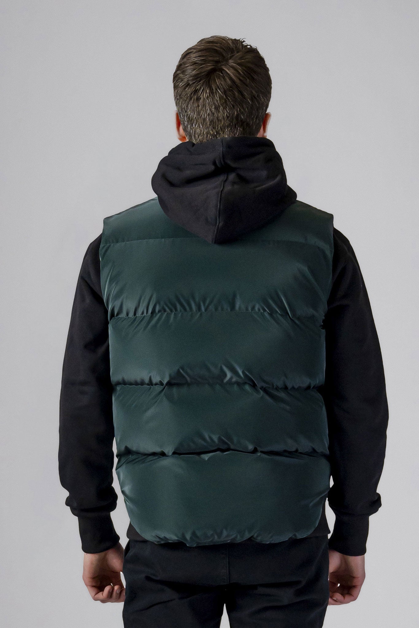 Woodpecker Unisex Winter Vest. High-end Canadian designer winter vest in "Green Diamond" colour. Woodpecker cruelty-free vest designed in Canada. Heavy weight short length premium designer vest for winter. Superior quality warm winter vest. Moose Knuckles, Canada Goose, Mackage, Montcler, Will Poho, Willbird, Nic Bayley. Extra warm. Shiny vest. Stylish winter vest. Designer winter vest.