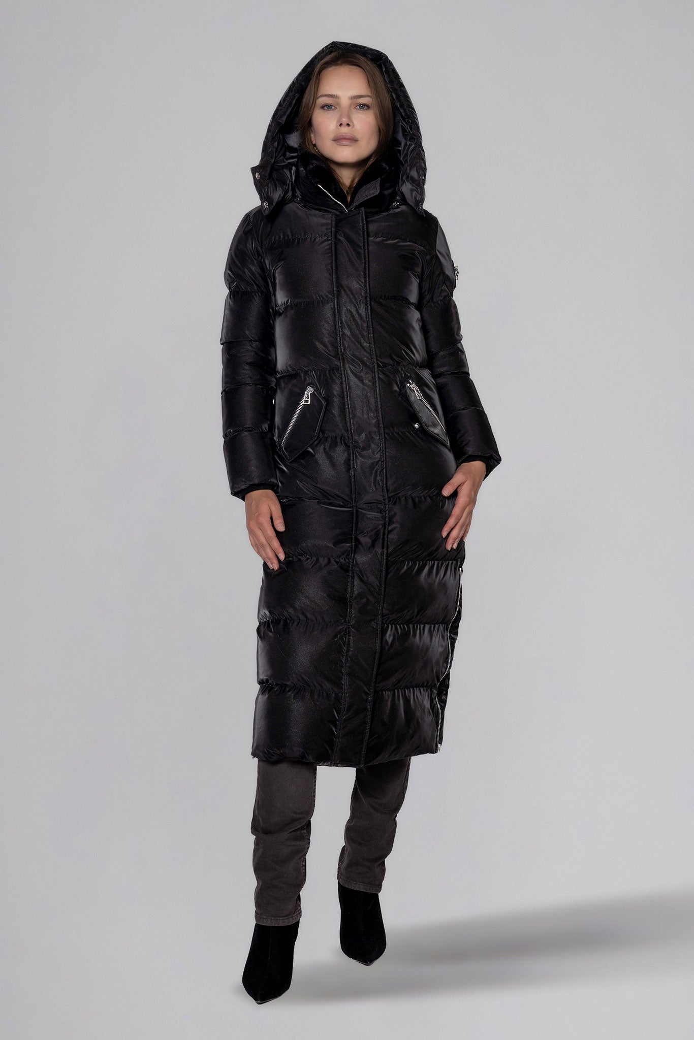Woodpecker Women's Extra Long Bird of Paradise Winter coat. High-end Canadian designer winter coat for women in “Black Diamond" colour. Woodpecker cruelty-free winter coat designed in Canada. Women's heavy weight extra long length premium designer jacket for winter. Superior quality warm winter coat for women. Moose Knuckles, Canada Goose, Mackage, Montcler, Will Poho, Willbird, Nic Bayley. Extra warm. Shiny parka. Stylish winter jacket. Designer winter coat.