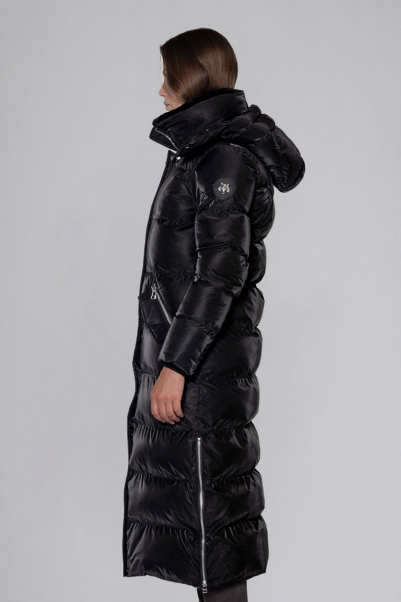 Woodpecker Women's Extra Long Bird of Paradise Winter coat. High-end Canadian designer winter coat for women in “Black Diamond" colour. Woodpecker cruelty-free winter coat designed in Canada. Women's heavy weight extra long length premium designer jacket for winter. Superior quality warm winter coat for women. Moose Knuckles, Canada Goose, Mackage, Montcler, Will Poho, Willbird, Nic Bayley. Extra warm. Shiny parka. Stylish winter jacket. Designer winter coat.