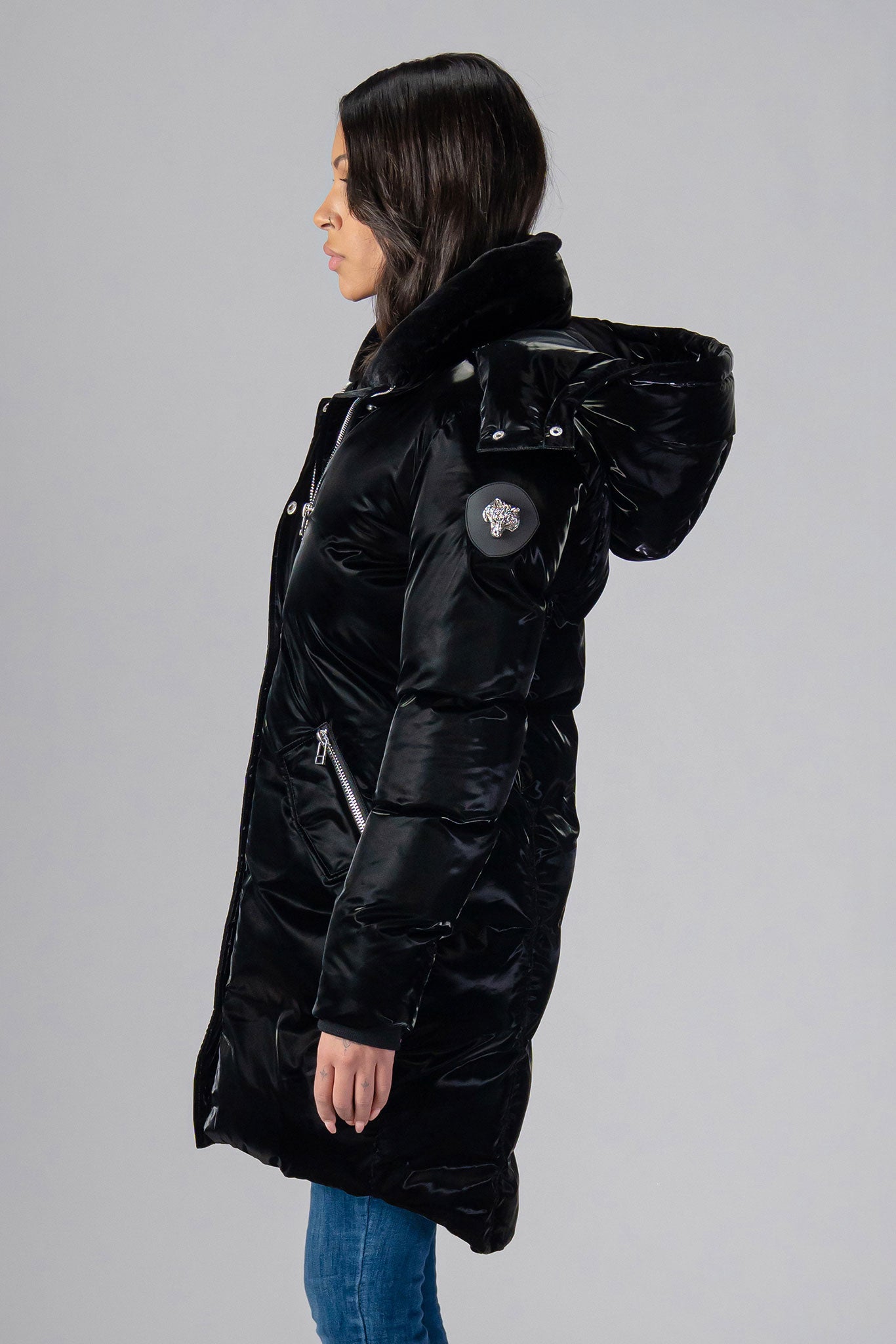 Woodpecker Women's Unquilted Penguin Long Winter coat. High-end Canadian designer winter coat for women in "All Wet Black" colour. Woodpecker cruelty-free winter coat designed in Canada. Women's heavy weight long length premium designer jacket for winter. Superior quality warm winter coat for women. Moose Knuckles, Canada Goose, Mackage, Montcler, Will Poho, Willbird, Nic Bayley. Extra warm. Shiny parka. Stylish winter jacket. Designer winter coat.