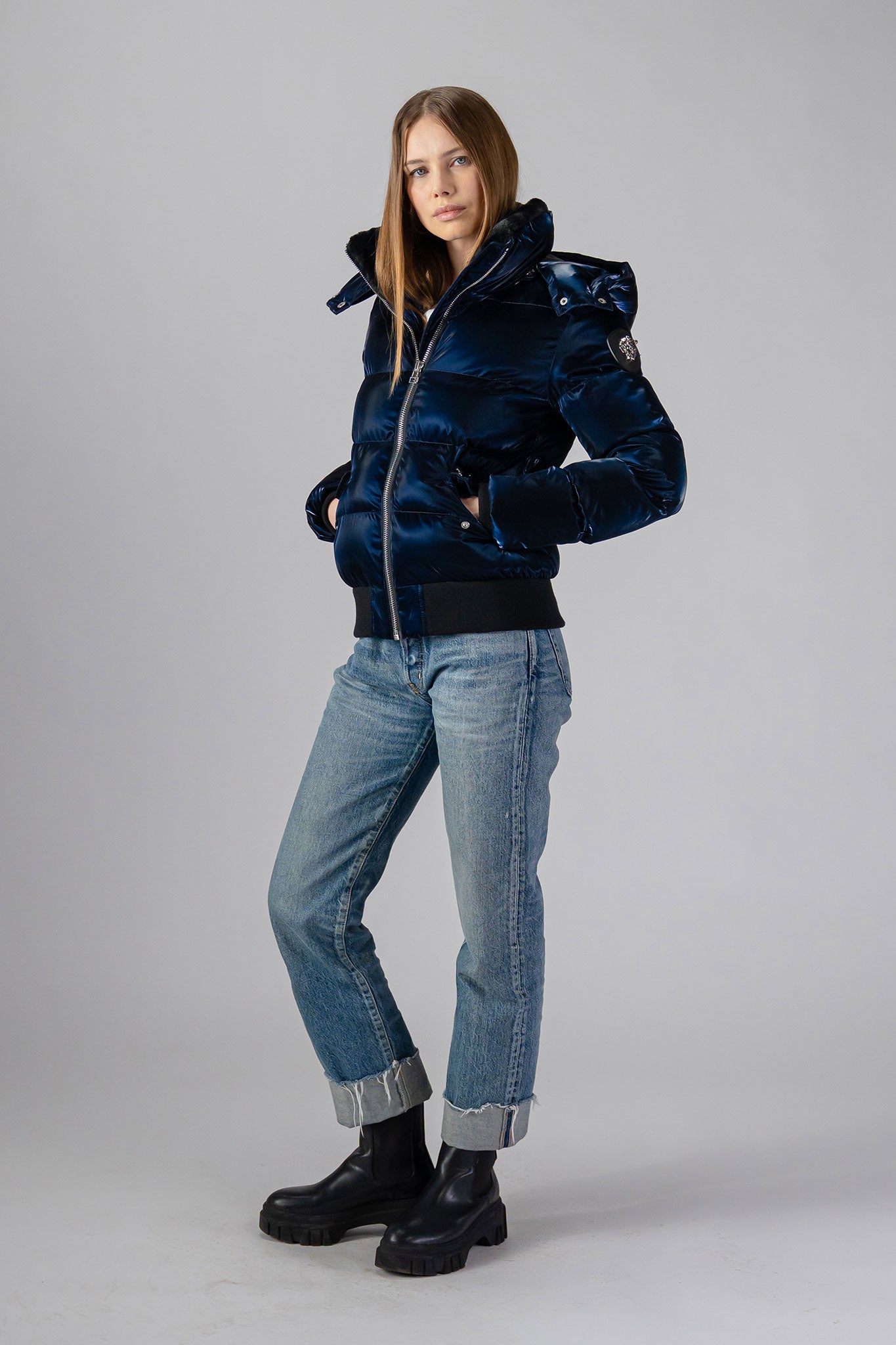 Woodpecker Women's Woody Bomber Winter coat. High-end Canadian designer winter coat for women in shiny “All Wet Navy". Woodpecker cruelty-free winter coat designed in Canada. Women's heavy weight short length premium designer jacket for winter. Superior quality warm winter coat for women. Moose Knuckles, Canada Goose, Mackage, Montcler, Will Poho, Willbird, Nic Bayley. Shiny parka. Stylish winter jacket. Designer winter coat.