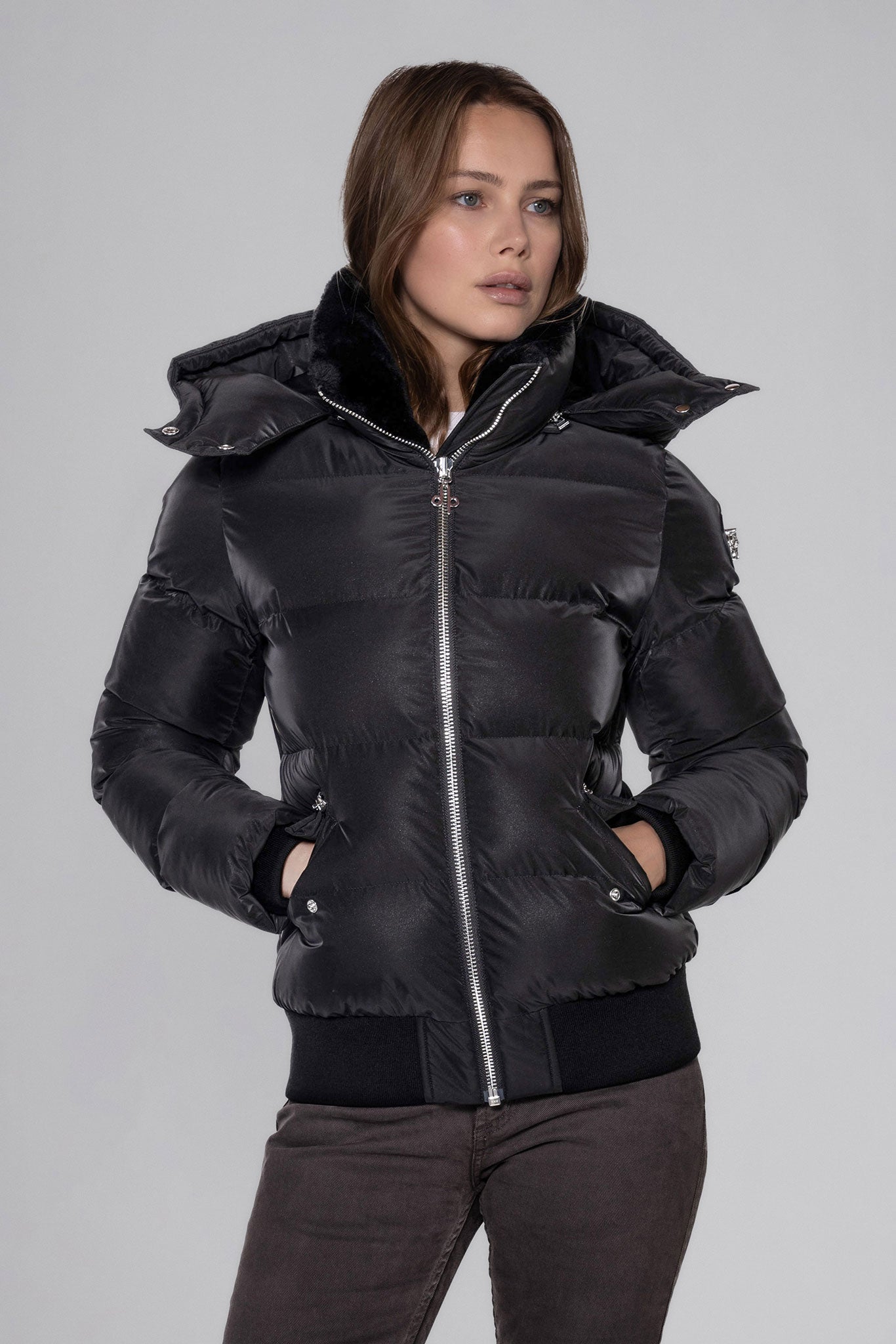 Woodpecker Women's Woody Bomber Winter coat. High-end Canadian designer winter coat for women in "Black Diamond" colour. Woodpecker cruelty-free winter coat designed in Canada. Women's heavy weight short length premium designer jacket for winter. Superior quality warm winter coat for women. Moose Knuckles, Canada Goose, Mackage, Montcler, Will Poho, Willbird, Nic Bayley. Shiny parka. Stylish winter jacket. Designer winter coat.