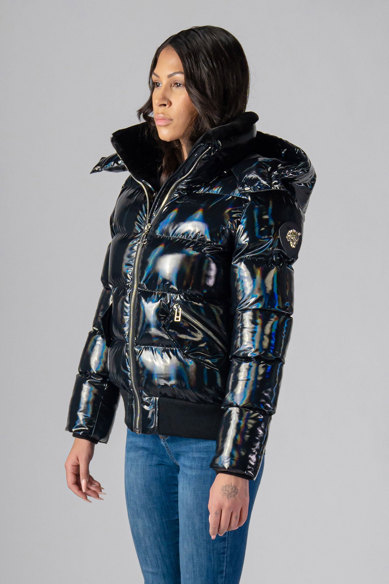 Woodpecker Women's Woody Bomber Winter coat. High-end Canadian designer winter coat for women in "Oily Black" colour. Woodpecker cruelty-free winter coat designed in Canada. Women's heavy weight short length premium designer jacket for winter. Superior quality warm winter coat for women. Moose Knuckles, Canada Goose, Mackage, Montcler, Will Poho, Willbird, Nic Bayley. Shiny parka. Stylish winter jacket. Designer winter coat.