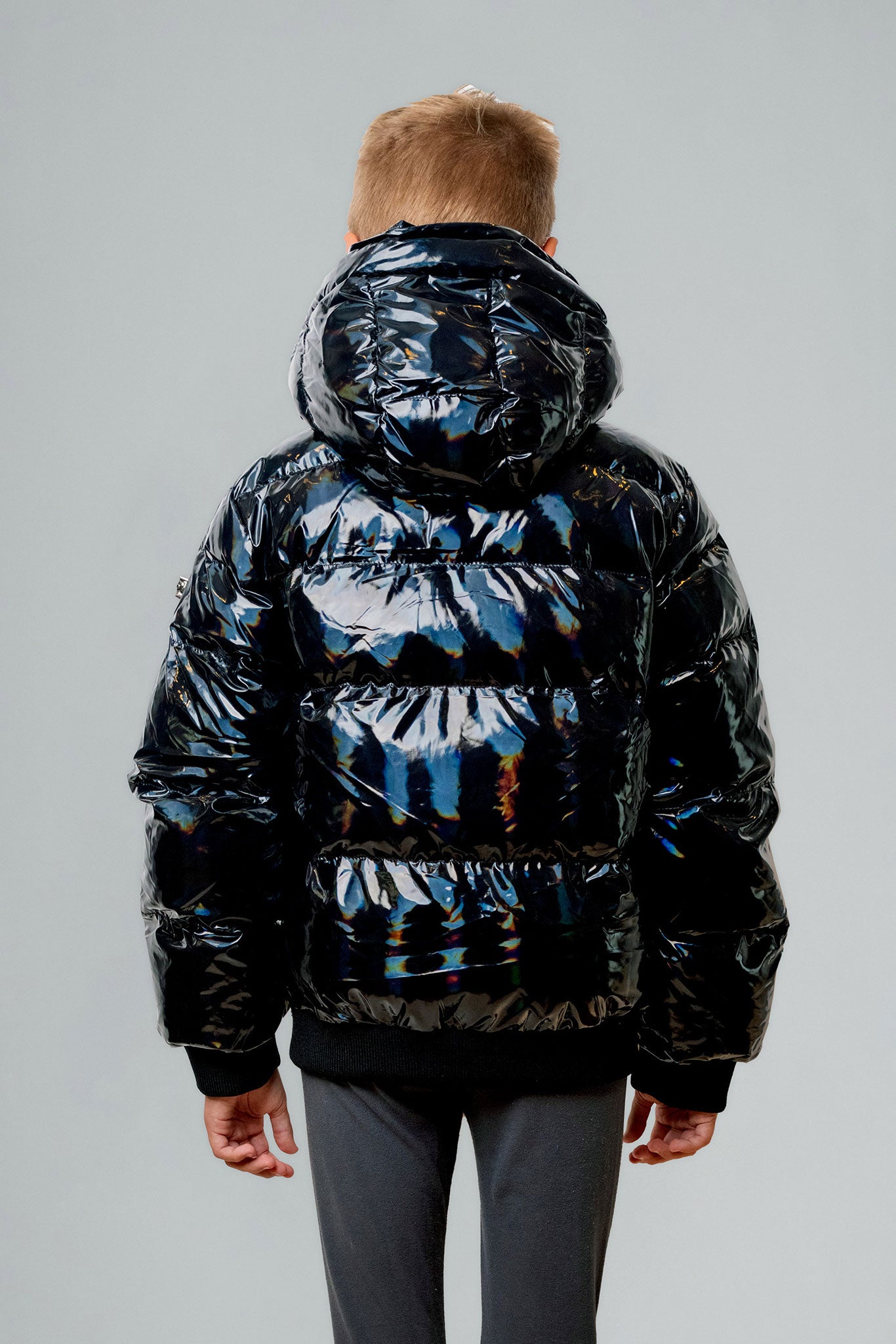 Woodpecker Kids' Chickadee Winter coat. High-end Canadian designer winter coat for Kids in "Oily Black" colour. Woodpecker cruelty-free winter coat designed in Canada. Kids' heavy weight short length premium designer jacket for winter. Superior quality warm winter coat for kids. Moose Knuckles, Canada Goose, Mackage, Montcler, Will Poho, Willbird, Nic Bayley. Extra Warm. Shiny parka. Stylish winter jacket. Designer winter coat.