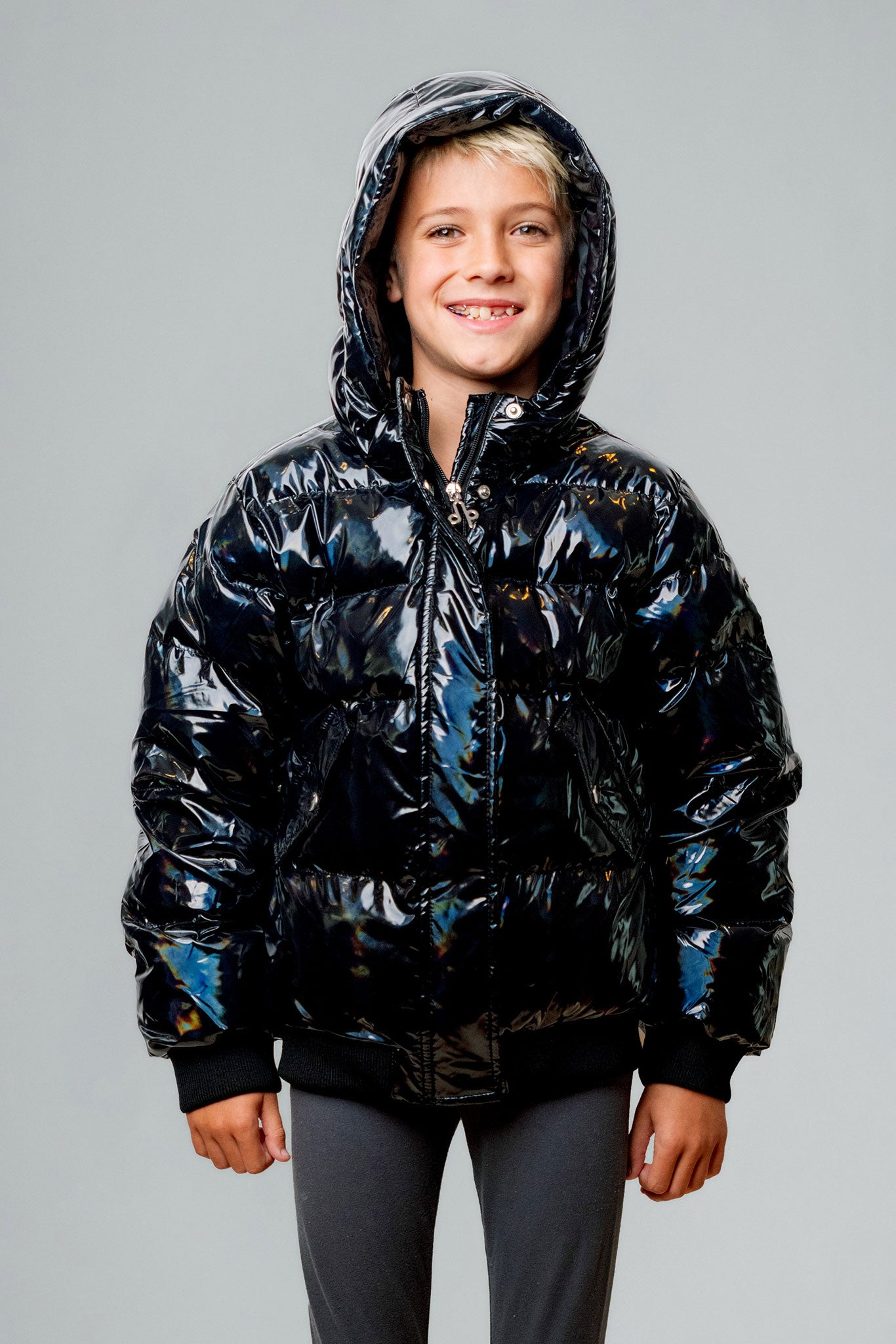 Woodpecker Kids' Chickadee Winter coat. High-end Canadian designer winter coat for Kids in "Oily Black" colour. Woodpecker cruelty-free winter coat designed in Canada. Kids' heavy weight short length premium designer jacket for winter. Superior quality warm winter coat for kids. Moose Knuckles, Canada Goose, Mackage, Montcler, Will Poho, Willbird, Nic Bayley. Extra Warm. Shiny parka. Stylish winter jacket. Designer winter coat.