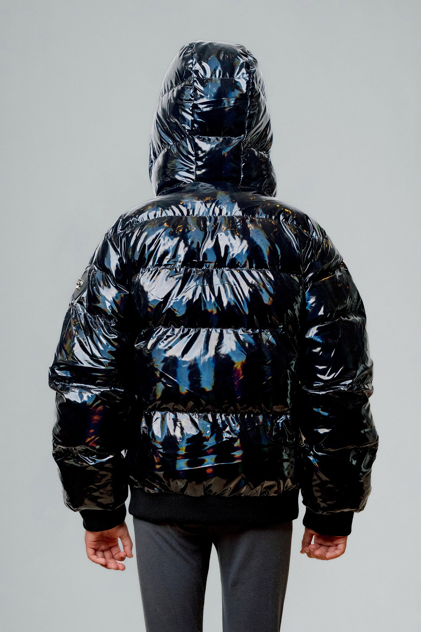 Woodpecker Kids' Chickadee Winter coat. High-end Canadian designer winter coat for Kids in "Oily Black" colour. Woodpecker cruelty-free winter coat designed in Canada. Kids' heavy weight short length premium designer jacket for winter. Superior quality warm winter coat for kids. Moose Knuckles, Canada Goose, Mackage, Montcler, Will Poho, Willbird, Nic Bayley. Extra Warm. Shiny parka. Stylish winter jacket. Designer winter coat.