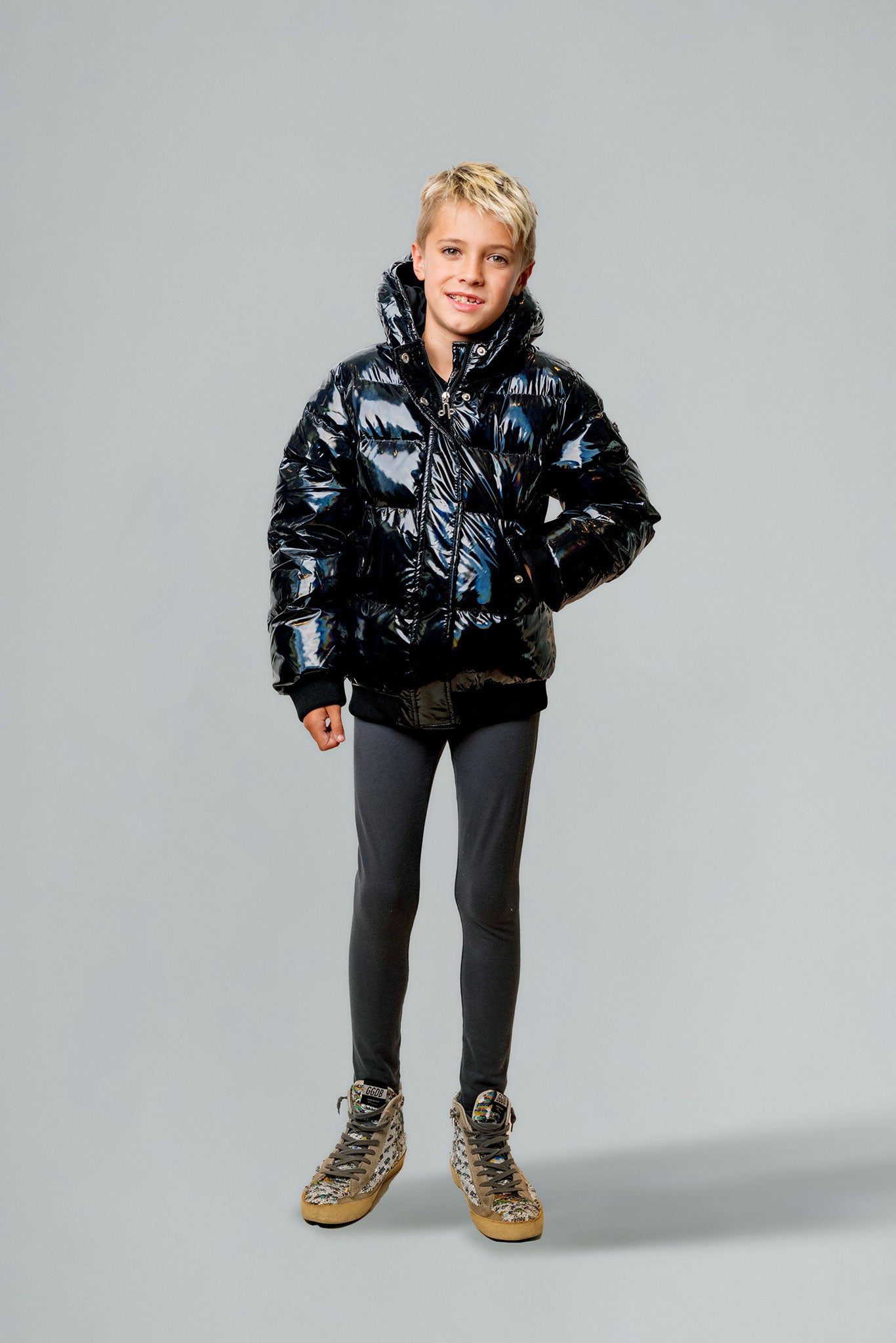 Woodpecker Kids' Chickadee Winter coat. High-end Canadian designer winter coat for Kids in "Oily Black" colour. Woodpecker cruelty-free winter coat designed in Canada. Kids' heavy weight short length premium designer jacket for winter. Superior quality warm winter coat for kids. Moose Knuckles, Canada Goose, Mackage, Montcler, Will Poho, Willbird, Nic Bayley. Extra Warm. Shiny parka. Stylish winter jacket. Designer winter coat.