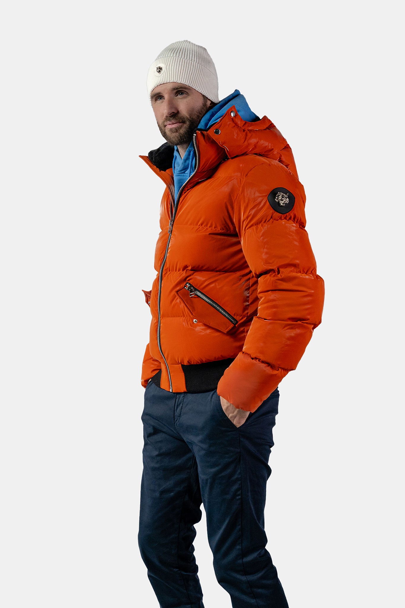 Woodpecker Men&#39;s Woody Bomber Winter coat. High-end Canadian designer winter coat for men in &quot;All Wet Orange&quot; colour. Woodpecker cruelty-free winter coat designed in Canada. Men&#39;s heavy weight short length premium designer jacket for winter. Superior quality warm winter coat for men. Moose Knuckles, Canada Goose, Mackage, Montcler, Will Poho, Willbird, Nic Bayley. Shiny parka. Stylish winter jacket. Designer winter coat.