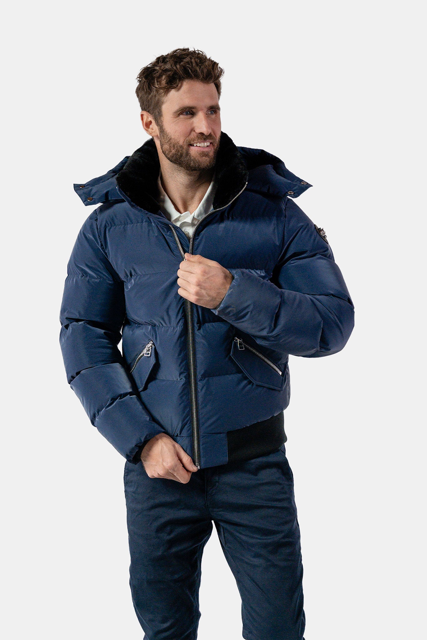 Woodpecker Men&#39;s Woody Bomber Winter coat. High-end Canadian designer winter coat for men in &quot;Sapphire Diamond&quot; colour. Woodpecker cruelty-free winter coat designed in Canada. Men&#39;s heavy weight short length premium designer jacket for winter. Superior quality warm winter coat for men. Moose Knuckles, Canada Goose, Mackage, Montcler, Will Poho, Willbird, Nic Bayley. Shiny parka. Stylish winter jacket. Designer winter coat.