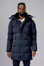 Load image into Gallery viewer, Woodpecker Men&#39;s Penguin Long Winter coat. High-end Canadian designer winter coat for men in &quot;Blue Diamond&quot; colour. Woodpecker cruelty-free winter coat designed in Canada. Men&#39;s heavy weight long length premium designer jacket for winter. Superior quality warm winter coat for men. Moose Knuckles, Canada Goose, Mackage, Montcler, Will Poho, Willbird, Nic Bayley. Extra warm. Shiny parka. Stylish winter jacket. Designer winter coat.

