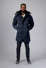 Load image into Gallery viewer, Woodpecker Men&#39;s Penguin Long Winter coat. High-end Canadian designer winter coat for men in &quot;Blue Diamond&quot; colour. Woodpecker cruelty-free winter coat designed in Canada. Men&#39;s heavy weight long length premium designer jacket for winter. Superior quality warm winter coat for men. Moose Knuckles, Canada Goose, Mackage, Montcler, Will Poho, Willbird, Nic Bayley. Extra warm. Shiny parka. Stylish winter jacket. Designer winter coat.
