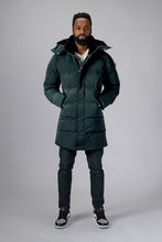 Load image into Gallery viewer, Woodpecker Men&#39;s Penguin Long Winter coat. High-end Canadian designer winter coat for men in &quot;Green Diamond&quot; colour. Woodpecker cruelty-free winter coat designed in Canada. Men&#39;s heavy weight long length premium designer jacket for winter. Superior quality warm winter coat for men. Moose Knuckles, Canada Goose, Mackage, Montcler, Will Poho, Willbird, Nic Bayley. Extra warm. Shiny parka. Stylish winter jacket. Designer winter coat.
