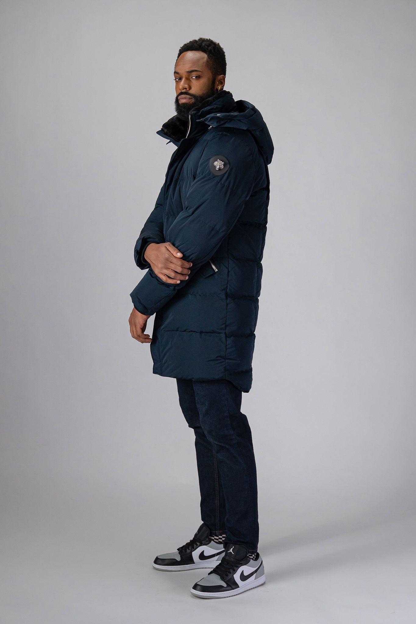 Woodpecker Men&#39;s Penguin Long Winter coat. High-end Canadian designer winter coat for men in “Matte Navy&quot; colour. Woodpecker cruelty-free winter coat designed in Canada. Men&#39;s heavy weight long length premium designer jacket for winter. Superior quality warm winter coat for men. Moose Knuckles, Canada Goose, Mackage, Montcler, Will Poho, Willbird, Nic Bayley. Extra warm. Shiny parka. Stylish winter jacket. Designer winter coat.