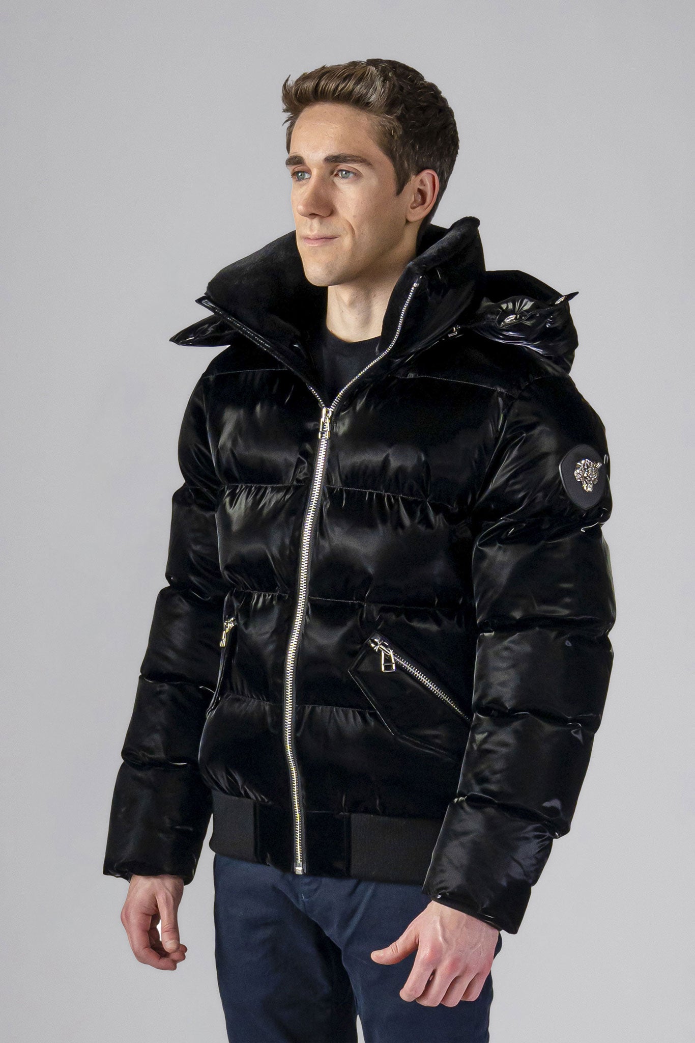 Woodpecker Men&#39;s Woody Bomber Winter coat. High-end Canadian designer winter coat for men in shiny “All Wet Black&quot; colour. Woodpecker cruelty-free winter coat designed in Canada. Men&#39;s heavy weight short length premium designer jacket for winter. Superior quality warm winter coat for men. Moose Knuckles, Canada Goose, Mackage, Montcler, Will Poho, Willbird, Nic Bayley. Shiny parka. Stylish winter jacket. Designer winter coat.