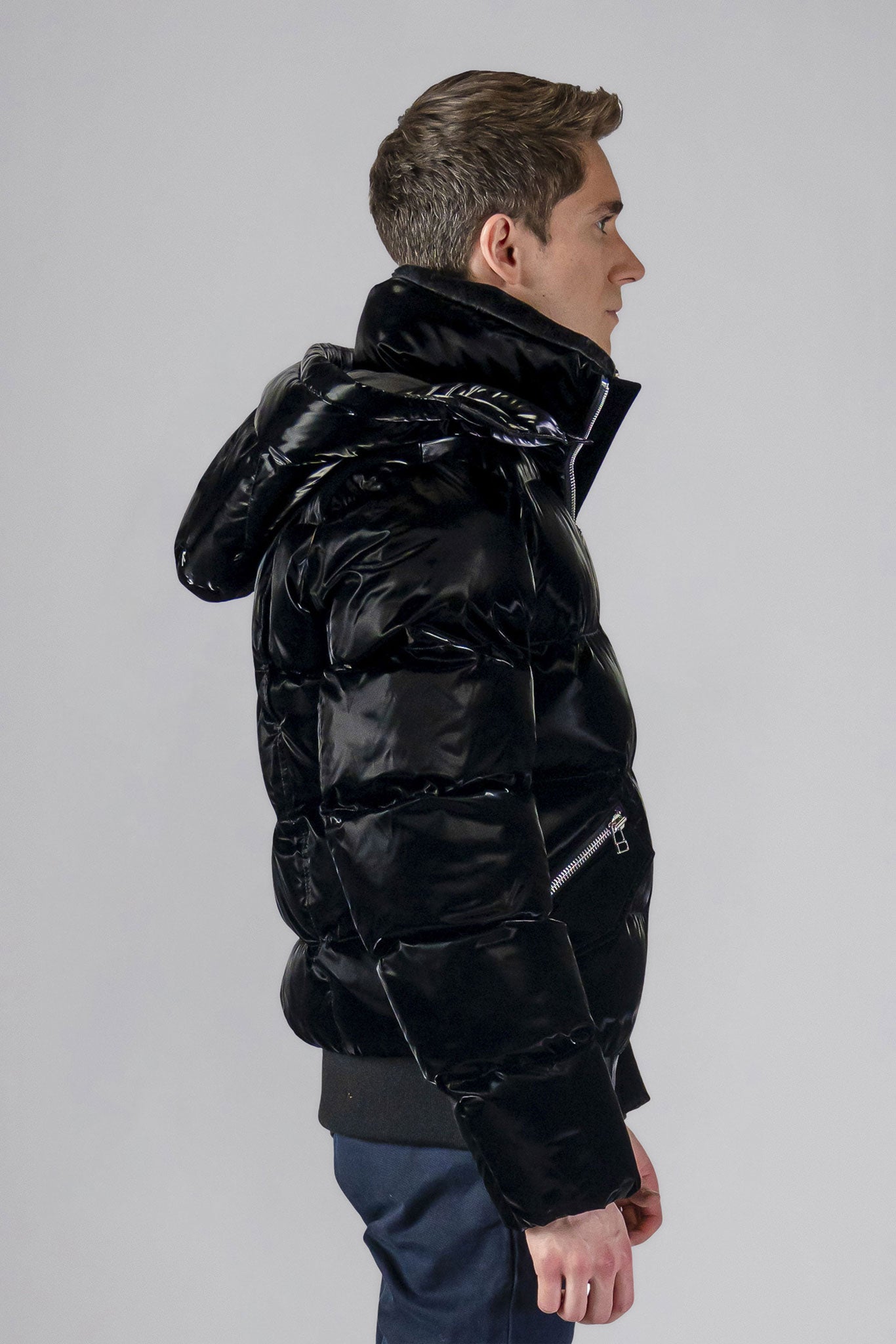 Woodpecker Men's Woody Bomber Winter coat. High-end Canadian designer winter coat for men in shiny “All Wet Black" colour. Woodpecker cruelty-free winter coat designed in Canada. Men's heavy weight short length premium designer jacket for winter. Superior quality warm winter coat for men. Moose Knuckles, Canada Goose, Mackage, Montcler, Will Poho, Willbird, Nic Bayley. Shiny parka. Stylish winter jacket. Designer winter coat.