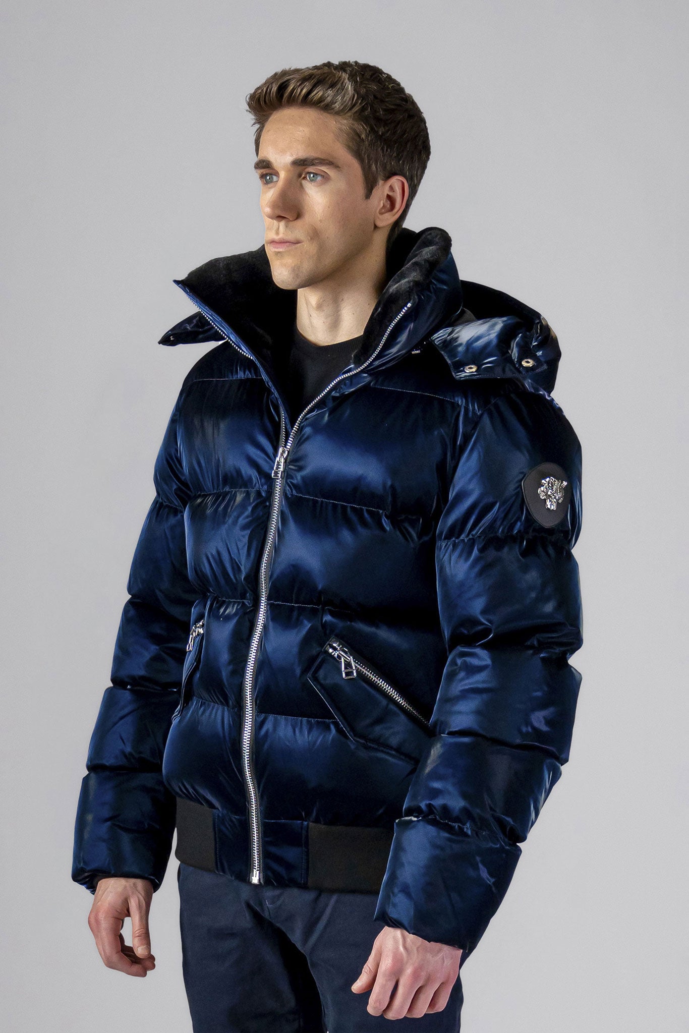 Woodpecker Men's Woody Bomber Winter coat. High-end Canadian designer winter coat for men in shiny “All Wet Navy" colour. Woodpecker cruelty-free winter coat designed in Canada. Men's heavy weight short length premium designer jacket for winter. Superior quality warm winter coat for men. Moose Knuckles, Canada Goose, Mackage, Montcler, Will Poho, Willbird, Nic Bayley. Shiny parka. Stylish winter jacket. Designer winter coat.