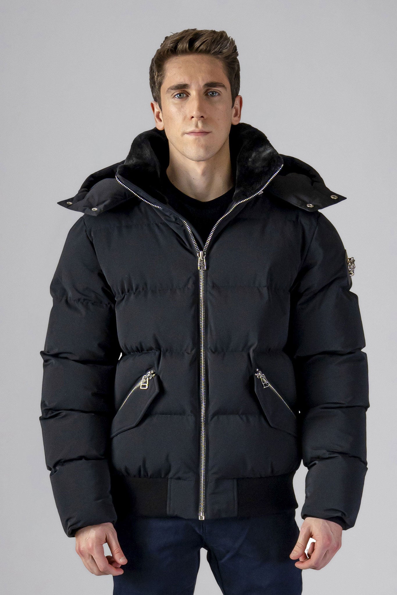 Woodpecker Men's Woody Bomber Winter coat. High-end Canadian designer winter coat for men in “Matte Black" colour. Woodpecker cruelty-free winter coat designed in Canada. Men's heavy weight short length premium designer jacket for winter. Superior quality warm winter coat for men. Moose Knuckles, Canada Goose, Mackage, Montcler, Will Poho, Willbird, Nic Bayley. Shiny parka. Stylish winter jacket. Designer winter coat.