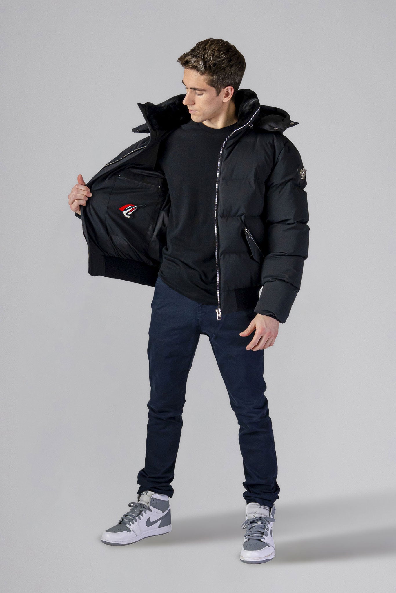 Woodpecker Men's Woody Bomber Winter coat. High-end Canadian designer winter coat for men in “Matte Black" colour. Woodpecker cruelty-free winter coat designed in Canada. Men's heavy weight short length premium designer jacket for winter. Superior quality warm winter coat for men. Moose Knuckles, Canada Goose, Mackage, Montcler, Will Poho, Willbird, Nic Bayley. Shiny parka. Stylish winter jacket. Designer winter coat.