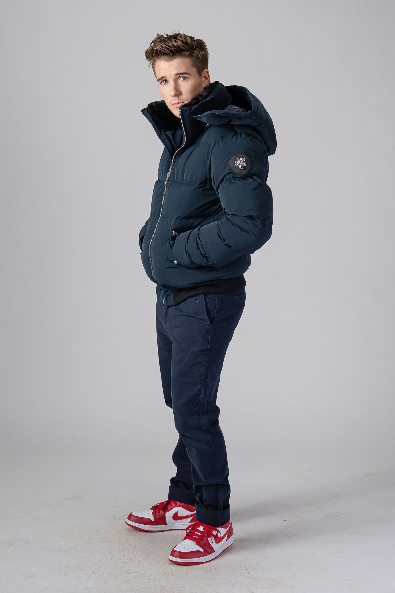 Woodpecker Men&#39;s Woody Bomber Winter coat. High-end Canadian designer winter coat for men in “Matte Navy&quot; colour. Woodpecker cruelty-free winter coat designed in Canada. Men&#39;s heavy weight short length premium designer jacket for winter. Superior quality warm winter coat for men. Moose Knuckles, Canada Goose, Mackage, Montcler, Will Poho, Willbird, Nic Bayley. Shiny parka. Stylish winter jacket. Designer winter coat.