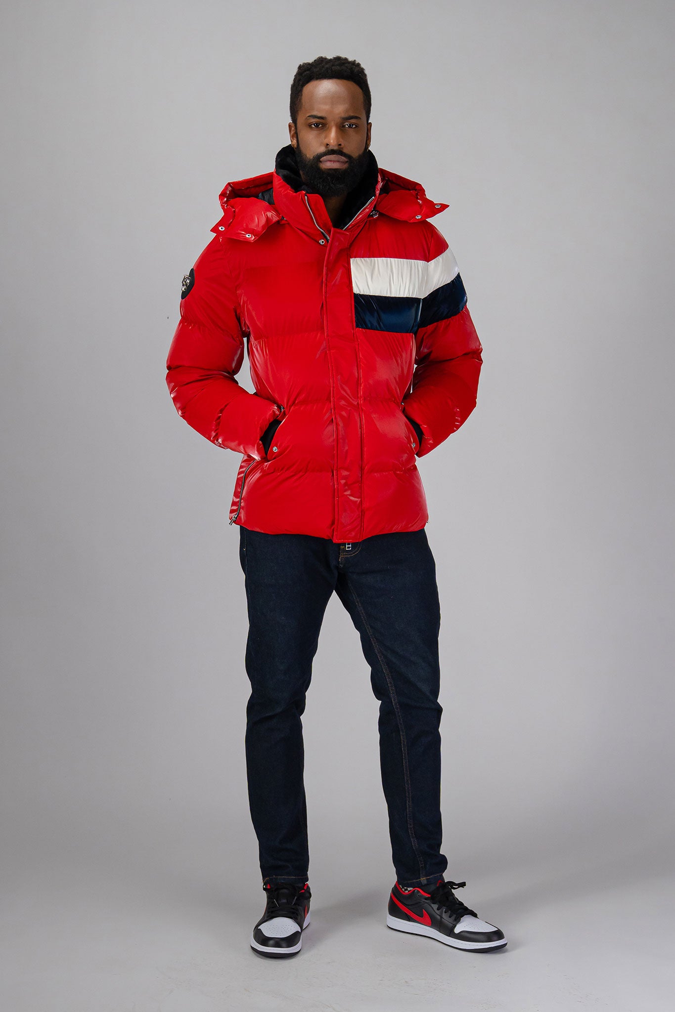 High-end Canadian designer winter coat for men in "Red White Blue" colour. Woodpecker cruelty-free winter coat designed in Canada. Men's heavy weight medium length premium designer jacket for winter. Superior quality warm winter coat for men. Moose Knuckles, Canada Goose, Mackage, Montcler, Will Poho, Willbird, Nic Bayley. Shiny parka. Stylish winter jacket. Designer winter coat.