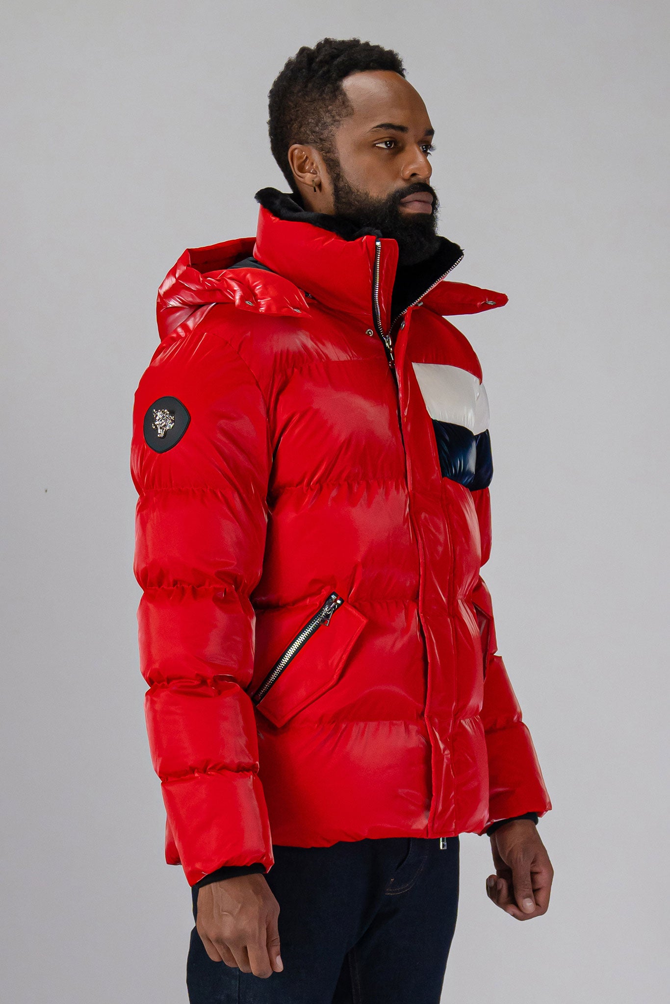 High-end Canadian designer winter coat for men in "Red White Blue" colour. Woodpecker cruelty-free winter coat designed in Canada. Men's heavy weight medium length premium designer jacket for winter. Superior quality warm winter coat for men. Moose Knuckles, Canada Goose, Mackage, Montcler, Will Poho, Willbird, Nic Bayley. Shiny parka. Stylish winter jacket. Designer winter coat.