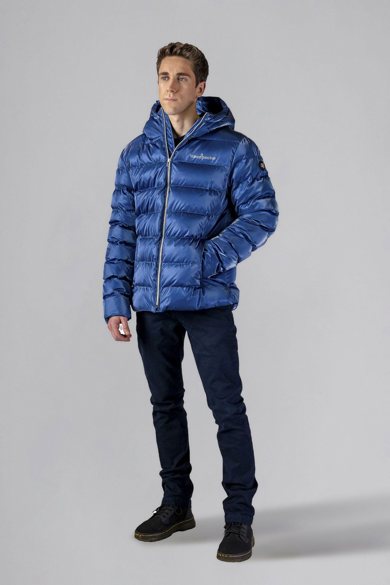 High-end Canadian designer winter coat for men in &quot;Flash Blue&quot; colour. Woodpecker cruelty-free winter coat designed in Canada. Men&#39;s medium weight medium length premium designer jacket for winter. Superior quality warm winter coat for men. Moose Knuckles, Canada Goose, Mackage, Montcler, Will Poho, Willbird, Nic Bayley. Shiny parka. Stylish winter jacket. Designer winter coat.