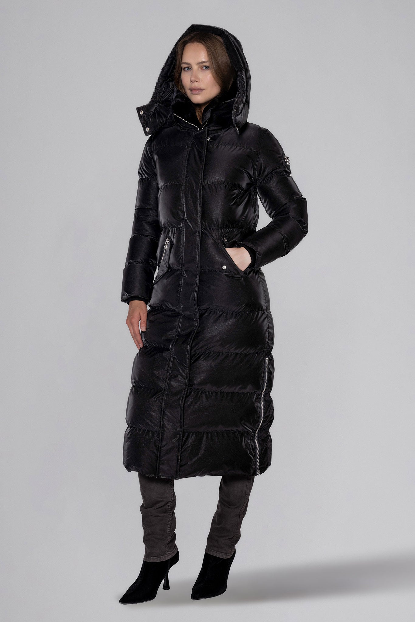 Woodpecker Women's Extra Long Bird of Paradise Winter coat. High-end Canadian designer winter coat for women in “Black Diamond" colour. Woodpecker cruelty-free winter coat designed in Canada. Women's heavy weight extra long length premium designer jacket for winter. Superior quality warm winter coat for women. Moose Knuckles, Canada Goose, Mackage, Montcler, Will Poho, Willbird, Nic Bayley. Extra warm. Shiny parka. Stylish winter jacket. Designer winter coat.