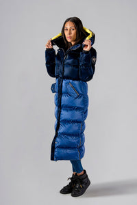 Woodpecker Women's Extra Long Bird of Paradise Winter coat. High-end Canadian designer winter coat for women in “Blue Yellow" colour. Woodpecker cruelty-free winter coat designed in Canada. Women's heavy weight extra long length premium designer jacket for winter. Superior quality warm winter coat for women. Moose Knuckles, Canada Goose, Mackage, Montcler, Will Poho, Willbird, Nic Bayley. Extra warm. Shiny parka. Stylish winter jacket. Designer winter coat.