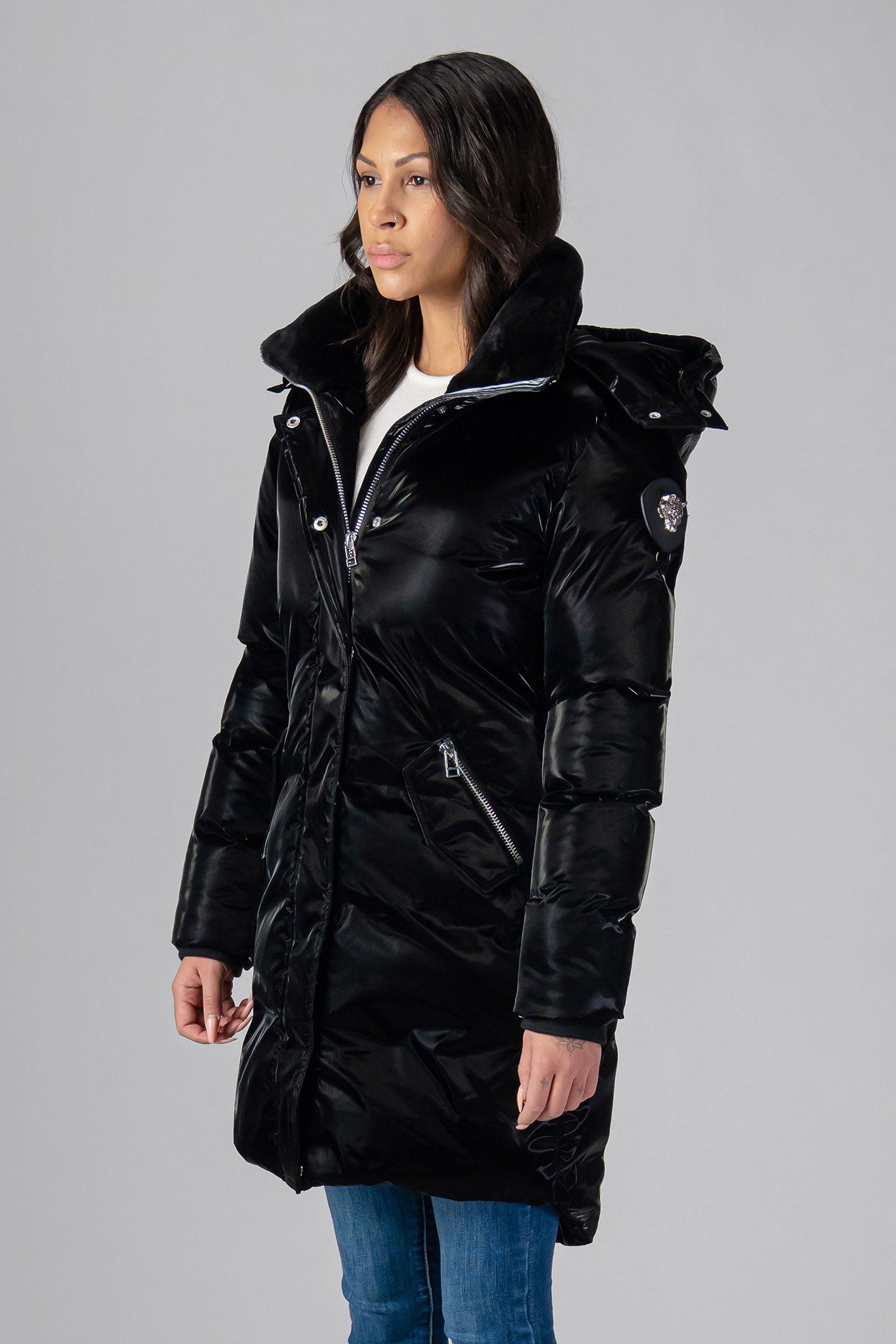 Woodpecker Women&#39;s Unquilted Penguin Long Winter coat. High-end Canadian designer winter coat for women in &quot;All Wet Black&quot; colour. Woodpecker cruelty-free winter coat designed in Canada. Women&#39;s heavy weight long length premium designer jacket for winter. Superior quality warm winter coat for women. Moose Knuckles, Canada Goose, Mackage, Montcler, Will Poho, Willbird, Nic Bayley. Extra warm. Shiny parka. Stylish winter jacket. Designer winter coat.