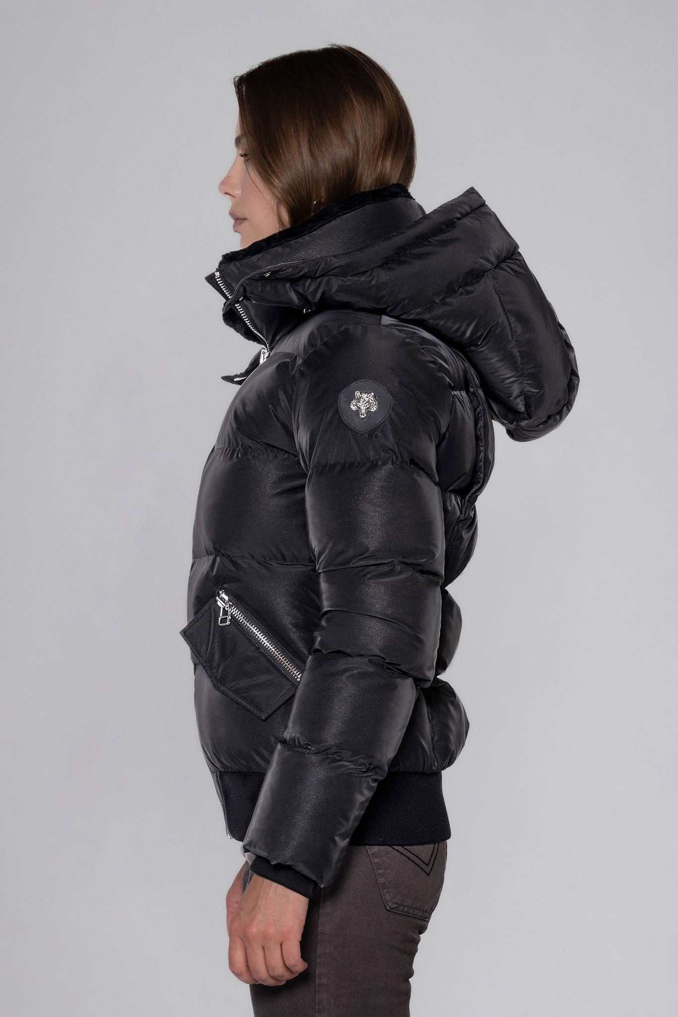 Woodpecker Women&#39;s Woody Bomber Winter coat. High-end Canadian designer winter coat for women in &quot;Black Diamond&quot; colour. Woodpecker cruelty-free winter coat designed in Canada. Women&#39;s heavy weight short length premium designer jacket for winter. Superior quality warm winter coat for women. Moose Knuckles, Canada Goose, Mackage, Montcler, Will Poho, Willbird, Nic Bayley. Shiny parka. Stylish winter jacket. Designer winter coat.