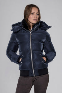 Woodpecker Women's Woody Bomber Winter coat. High-end Canadian designer winter coat for women in "Blue Diamond" colour. Woodpecker cruelty-free winter coat designed in Canada. Women's heavy weight short length premium designer jacket for winter. Superior quality warm winter coat for women. Moose Knuckles, Canada Goose, Mackage, Montcler, Will Poho, Willbird, Nic Bayley. Shiny parka. Stylish winter jacket. Designer winter coat.