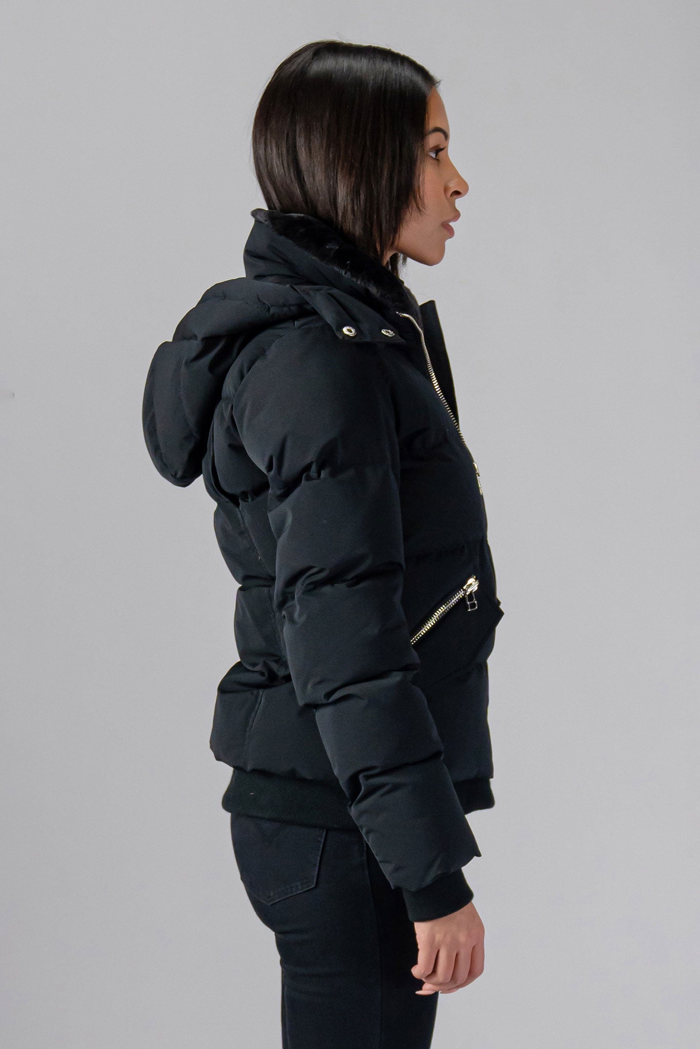 Woodpecker Women's Woody Bomber Winter coat. High-end Canadian designer winter coat for women in shiny “Matte Black" colour. Woodpecker cruelty-free winter coat designed in Canada. Women's heavy weight short length premium designer jacket for winter. Superior quality warm winter coat for women. Moose Knuckles, Canada Goose, Mackage, Montcler, Will Poho, Willbird, Nic Bayley. Shiny parka. Stylish winter jacket. Designer winter coat.