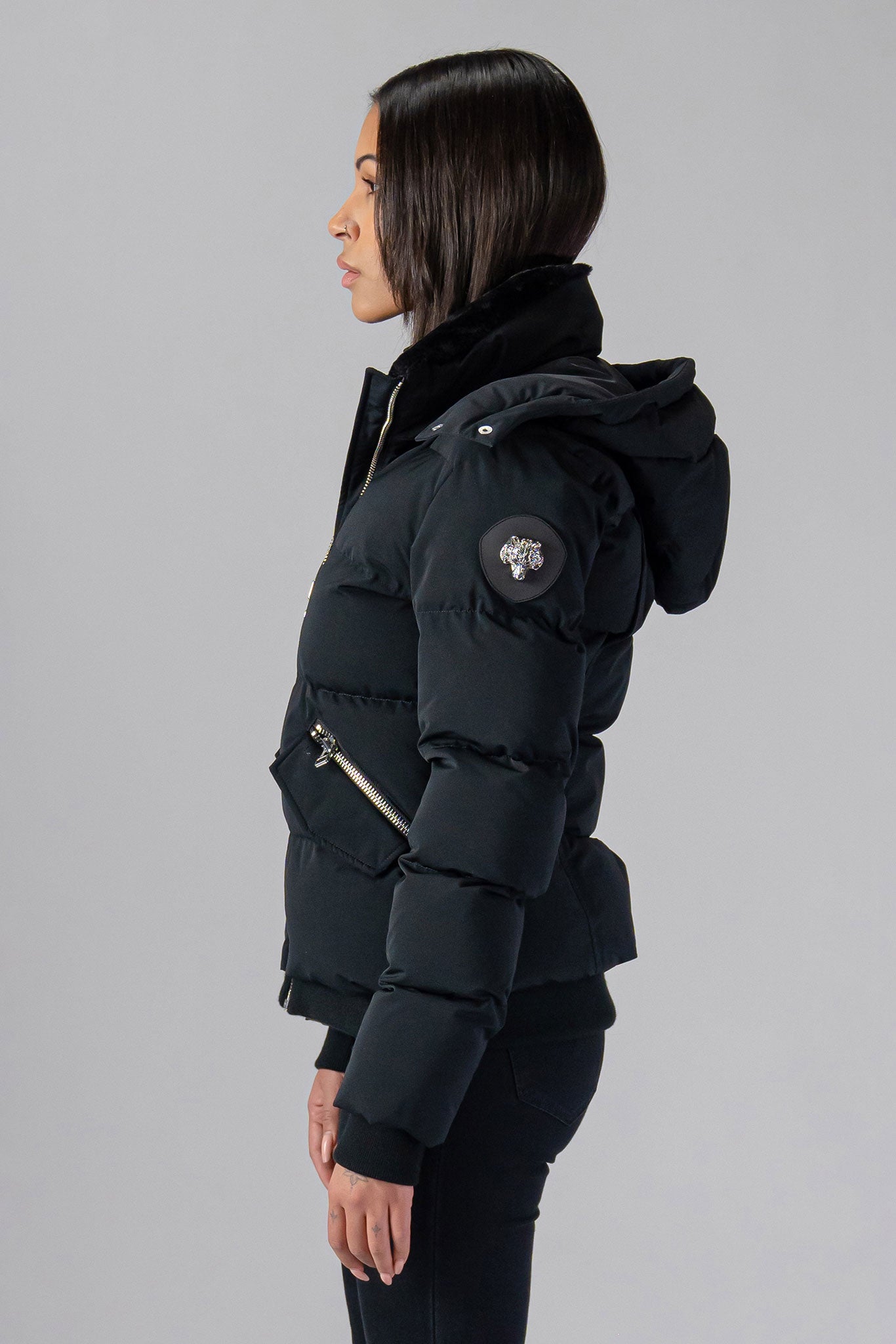 Woodpecker Women&#39;s Woody Bomber Winter coat. High-end Canadian designer winter coat for women in shiny “Matte Black&quot; colour. Woodpecker cruelty-free winter coat designed in Canada. Women&#39;s heavy weight short length premium designer jacket for winter. Superior quality warm winter coat for women. Moose Knuckles, Canada Goose, Mackage, Montcler, Will Poho, Willbird, Nic Bayley. Shiny parka. Stylish winter jacket. Designer winter coat.