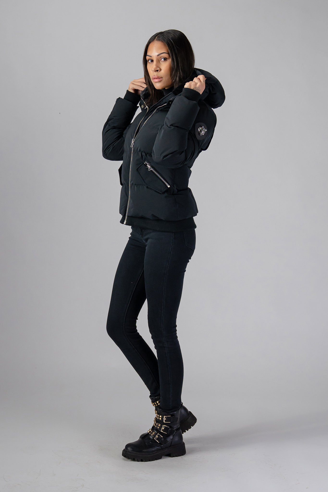 Woodpecker Women&#39;s Woody Bomber Winter coat. High-end Canadian designer winter coat for women in shiny “Matte Black&quot; colour. Woodpecker cruelty-free winter coat designed in Canada. Women&#39;s heavy weight short length premium designer jacket for winter. Superior quality warm winter coat for women. Moose Knuckles, Canada Goose, Mackage, Montcler, Will Poho, Willbird, Nic Bayley. Shiny parka. Stylish winter jacket. Designer winter coat.