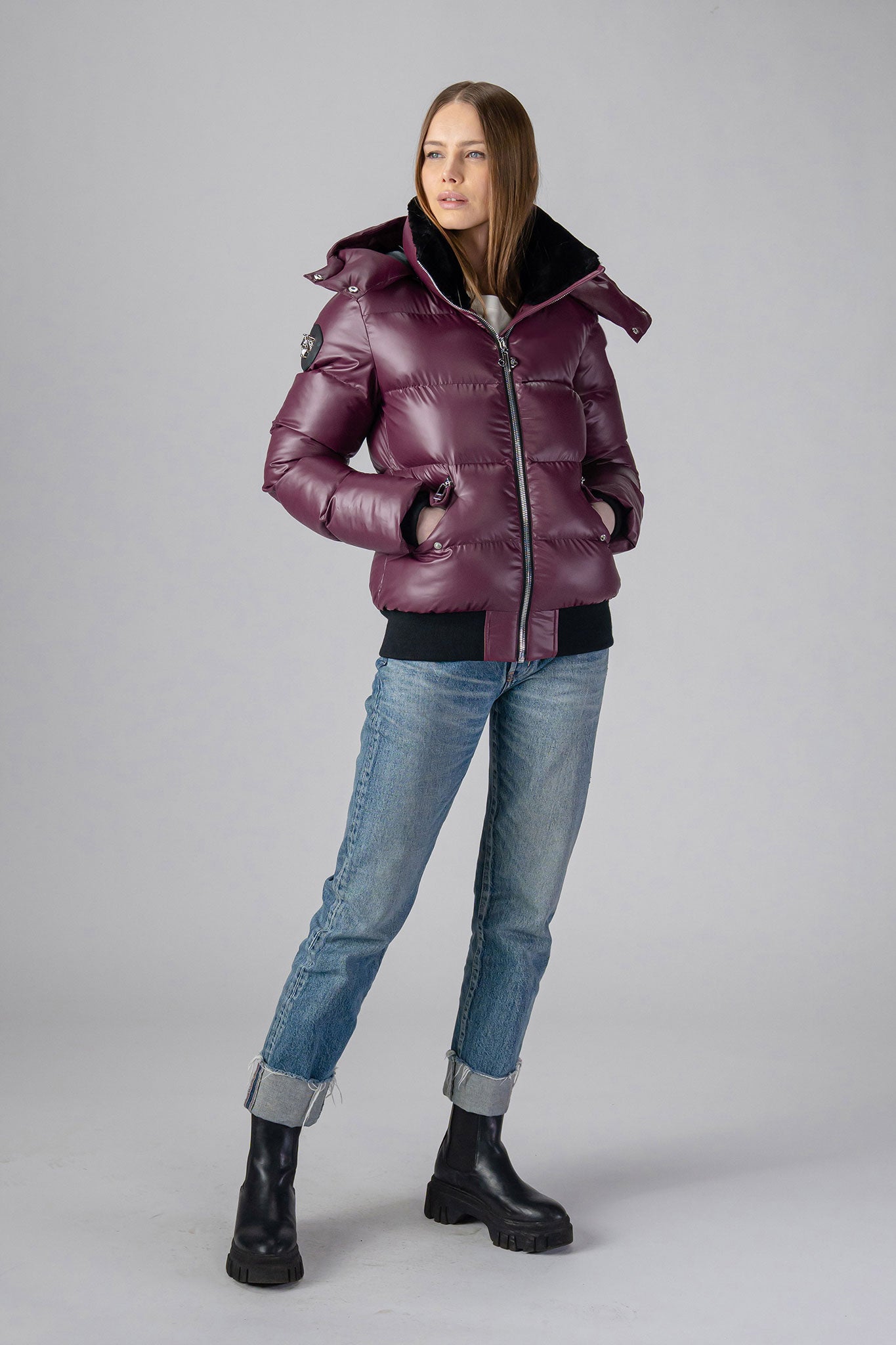 Woodpecker Women&#39;s Woody Bomber Winter coat. High-end Canadian designer winter coat for women in &quot;Plum&quot; colour. Woodpecker cruelty-free winter coat designed in Canada. Women&#39;s heavy weight short length premium designer jacket for winter. Superior quality warm winter coat for women. Moose Knuckles, Canada Goose, Mackage, Montcler, Will Poho, Willbird, Nic Bayley. Shiny parka. Stylish winter jacket. Designer winter coat.