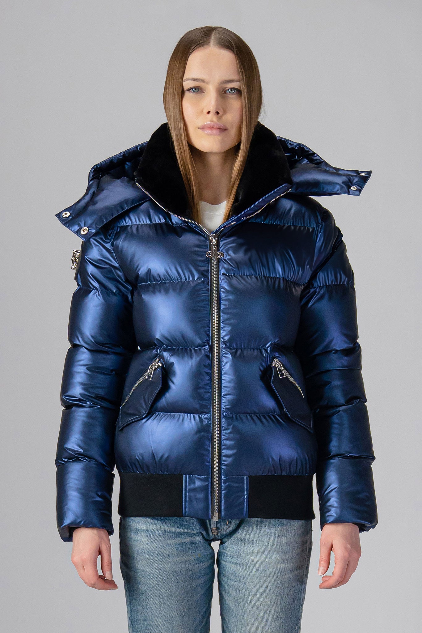 Woodpecker Women's Woody Bomber Winter coat. High-end Canadian designer winter coat for women in "Sapphire" colour. Woodpecker cruelty-free winter coat designed in Canada. Women's heavy weight short length premium designer jacket for winter. Superior quality warm winter coat for women. Moose Knuckles, Canada Goose, Mackage, Montcler, Will Poho, Willbird, Nic Bayley. Shiny parka. Stylish winter jacket. Designer winter coat.