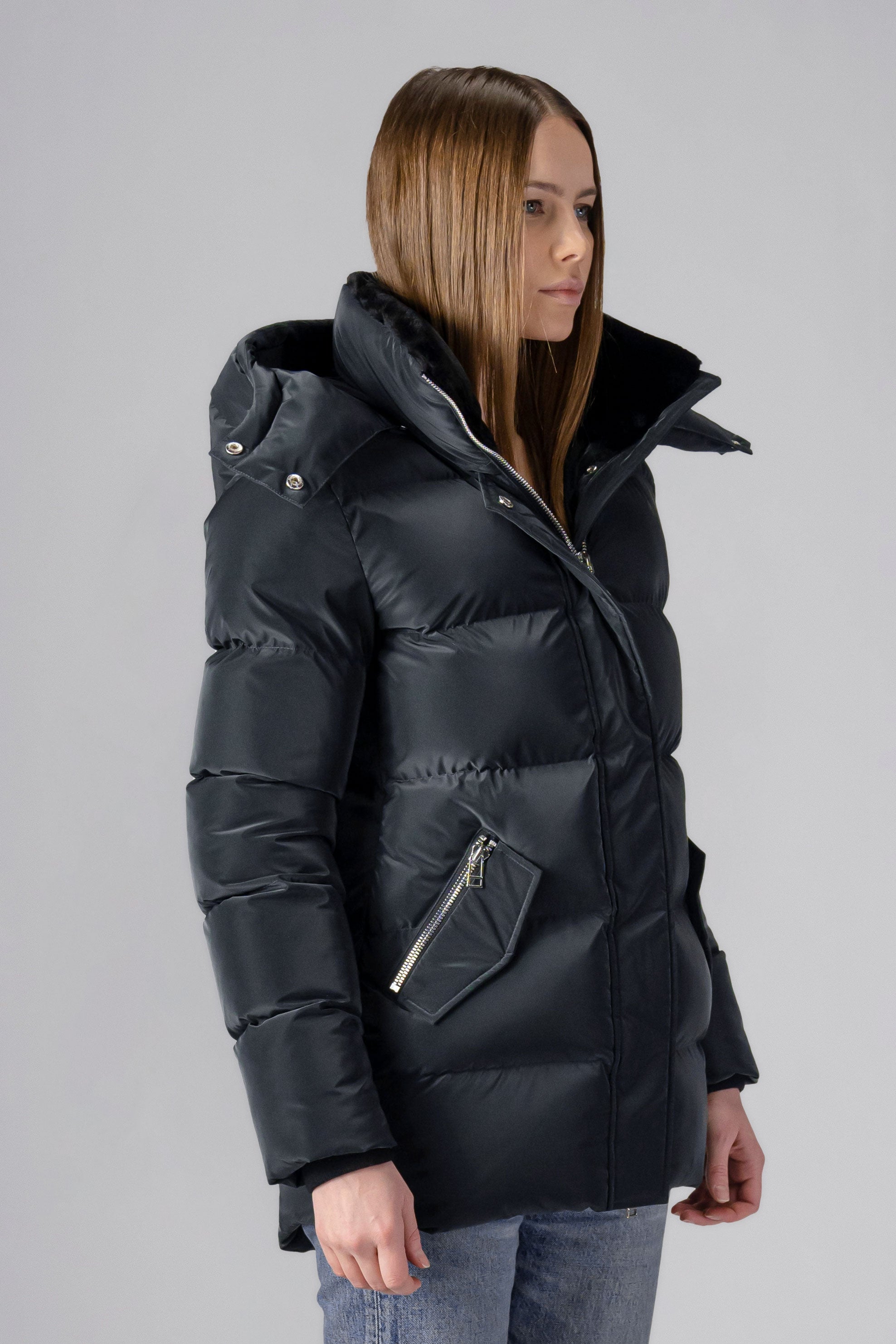 Woodpecker Women's Bumnester Winter coat. High-end Canadian designer winter coat for women in shiny "Black Diamond" colour. Woodpecker cruelty-free winter coat designed in Canada. Women's heavy weight medium length premium designer jacket for winter. Superior quality warm winter coat for women. Moose Knuckles, Canada Goose, Mackage, Montcler, Will Poho, Willbird, Nic Bayley. Extra warm. Shiny parka. Stylish winter jacket. Designer winter coat.